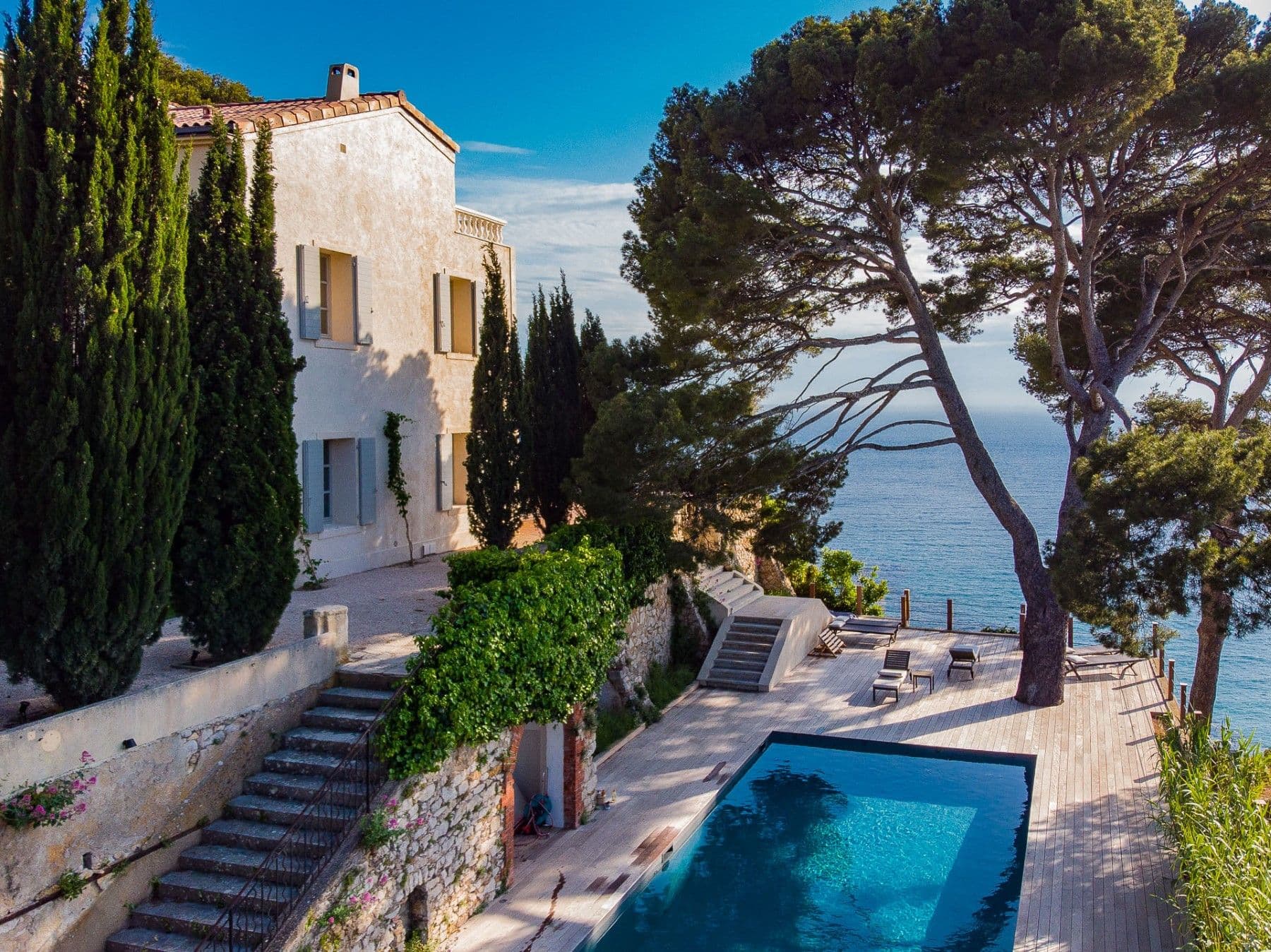 Swimming pool below the villa reached by stone steps with a sea view at Be Our Guest, Cassis, France
