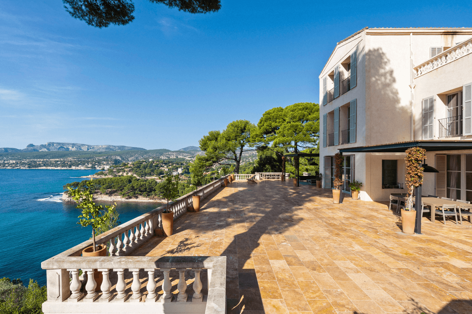 Covered terrace lounge under a slatted pergola with sea views at Be Our Guest, Cassis, France