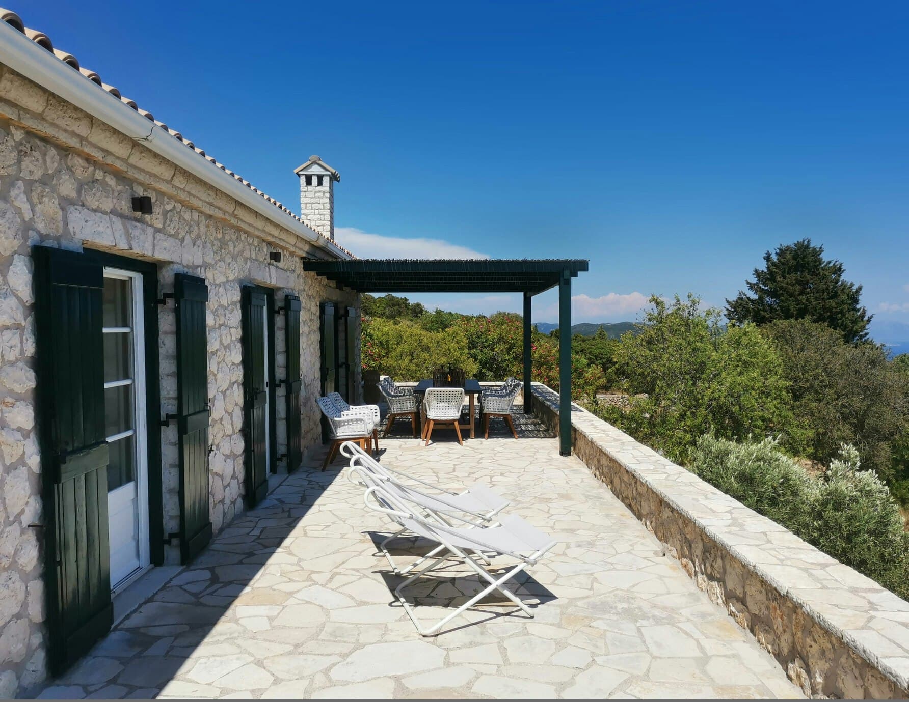 Sunset & Sea Lilies villa exterior with stone facade and sea view terrace, Lefkada, Greece