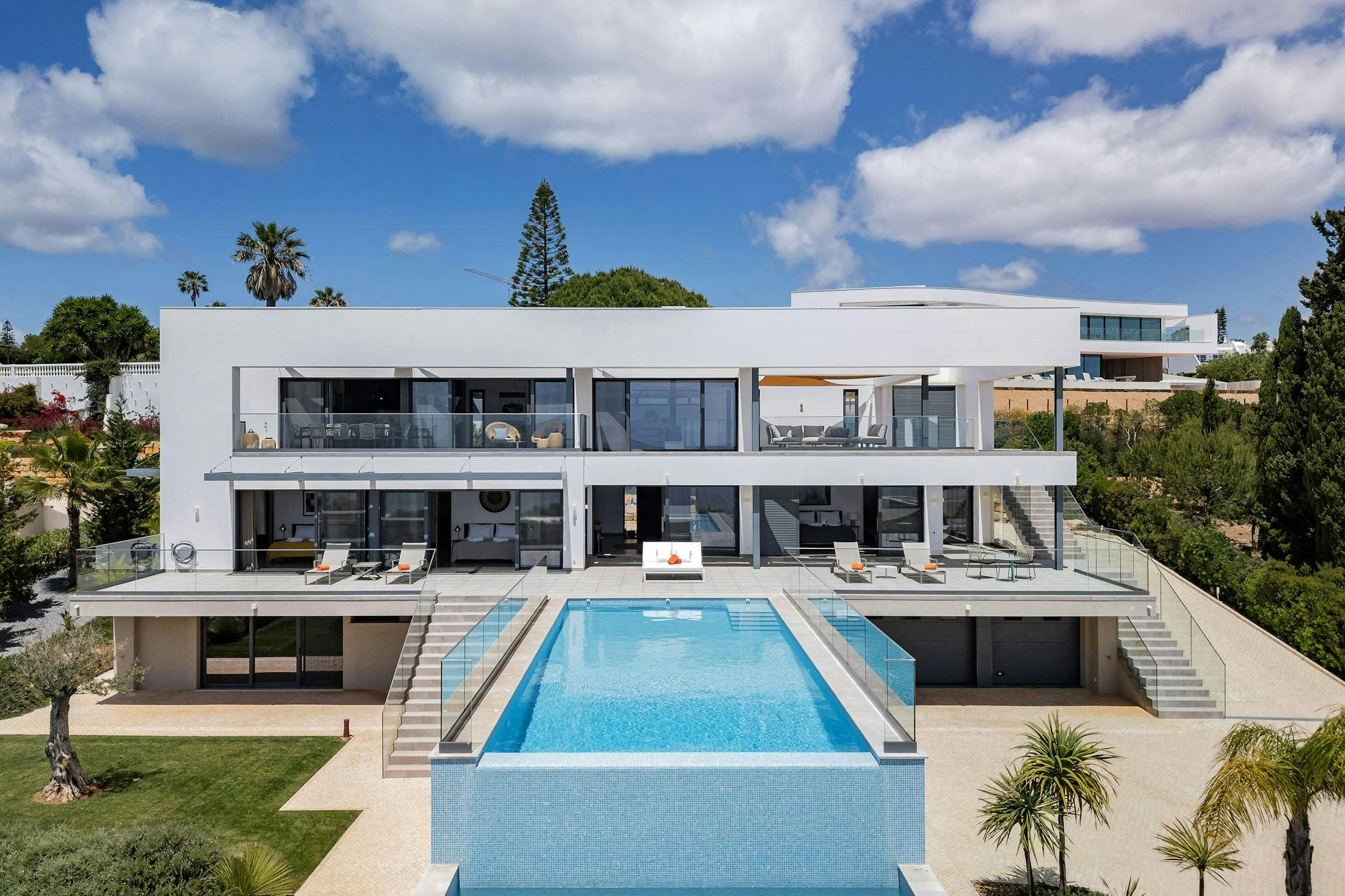 Graceful Shores villa exterior with infinity pool and glass walls, Luz, Algarve, Portugal