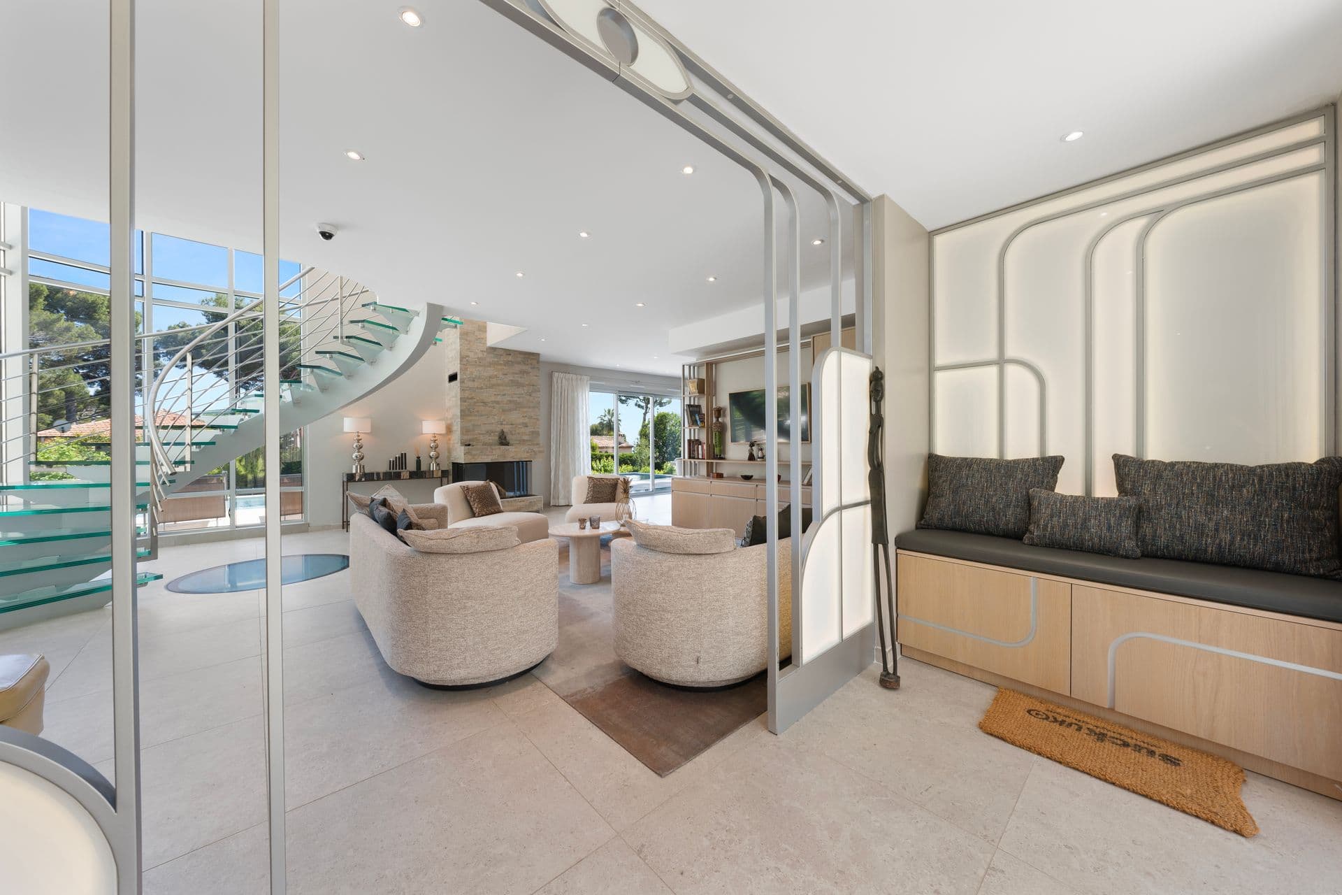 Lounge corner with a built-in window seat and curved armchairs at Above Antibes