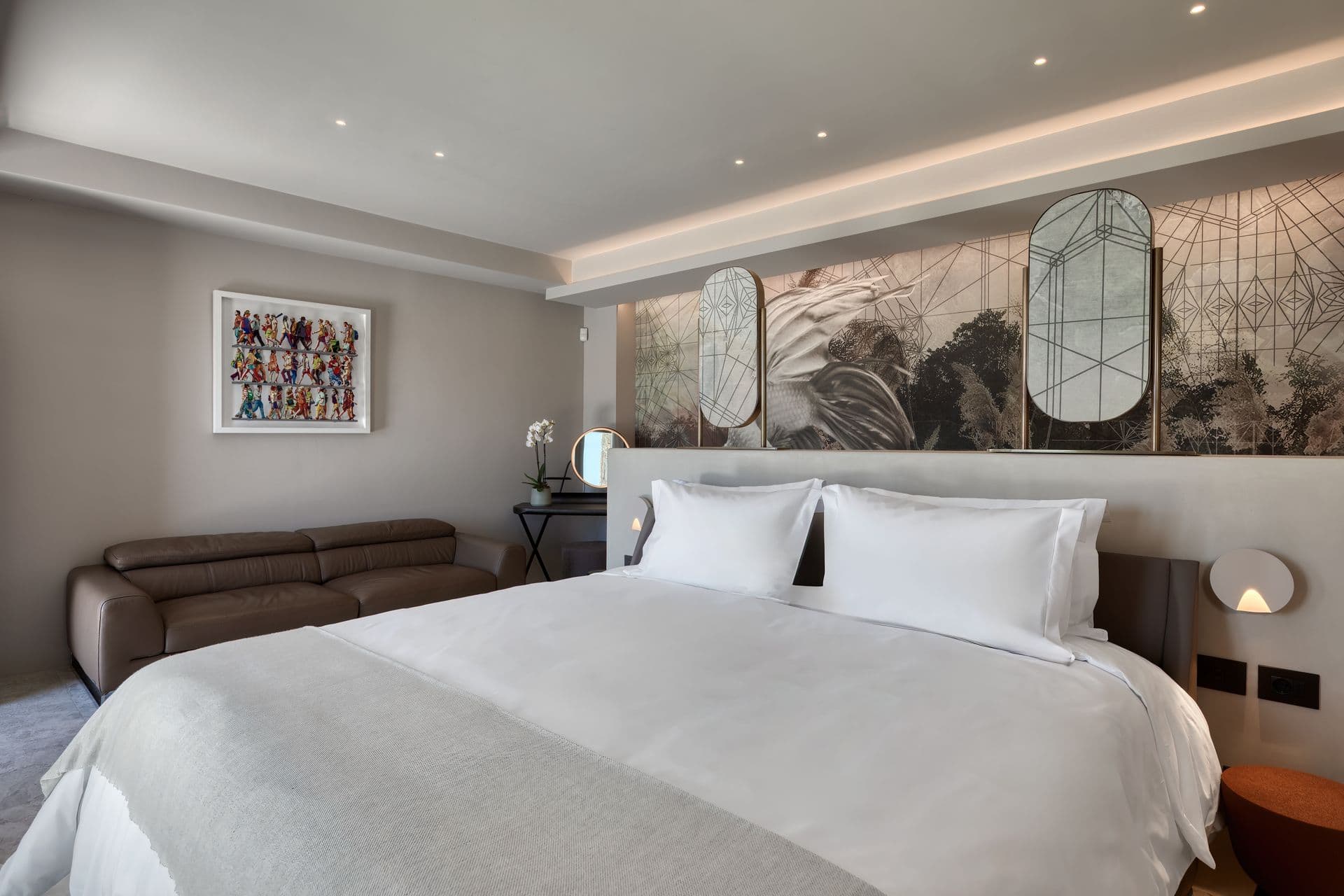 Double bedroom with an artwork headboard wall and soft lighting at Aegean Aspect, Mykonos