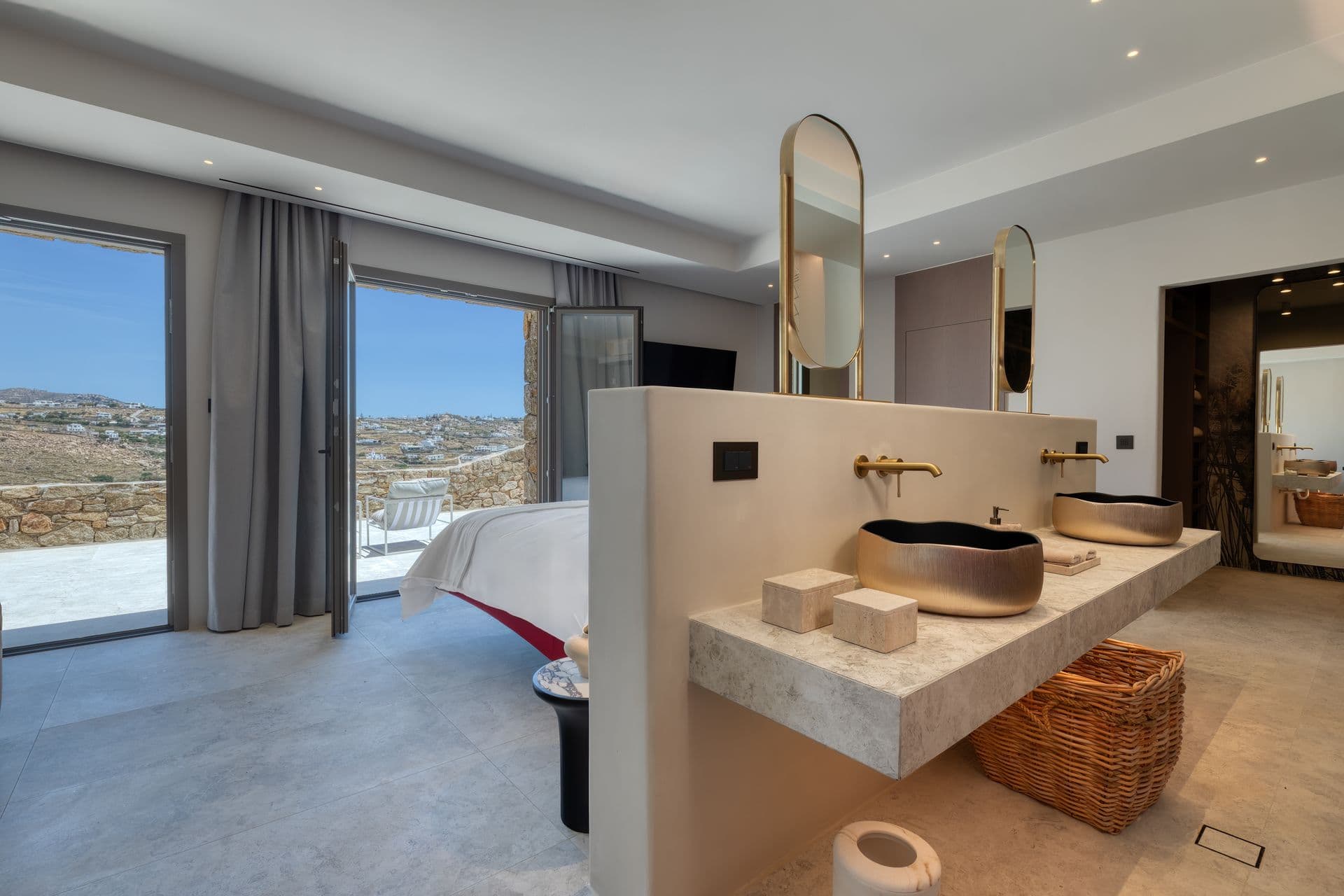 En-suite with twin stone vessel basins open to the bedroom and sea view at Aegean Aspect, Mykonos