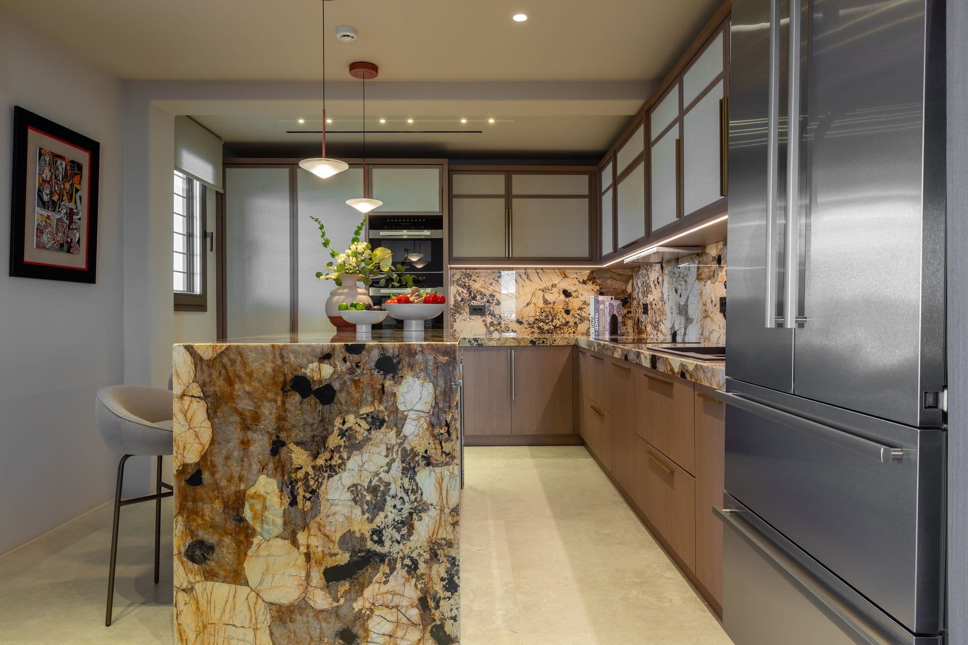 Kitchen with a dramatic patterned-marble island and breakfast bar at Aegean Aspect, Mykonos