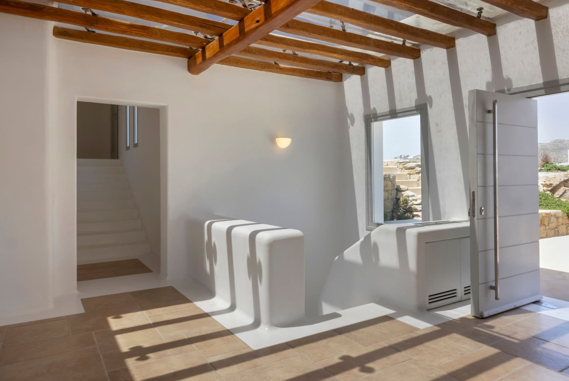 Whitewashed entrance hallway with exposed wooden beam ceiling