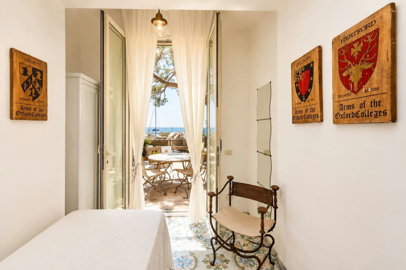 Faraglioni Frills guest bedroom with antique details and sea views, Capri, Italy