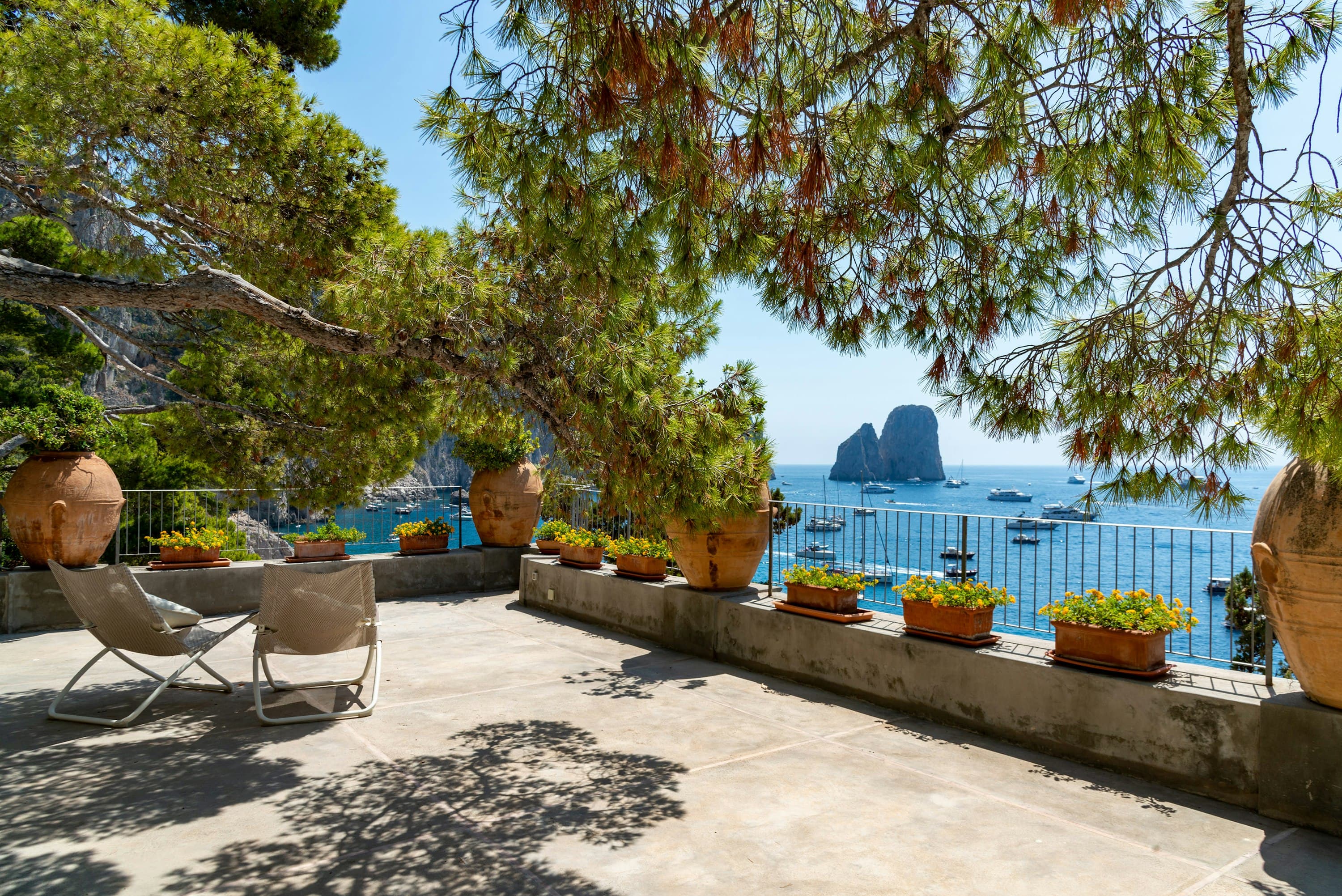 Faraglioni Frills terrace overlooking Capri's iconic rock formations, Amalfi Coast, Italy