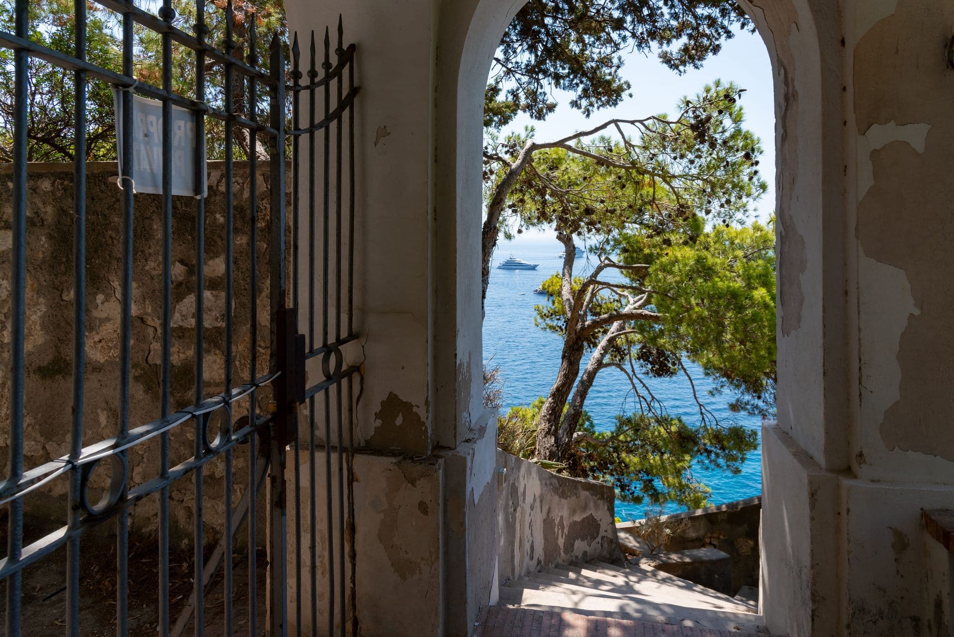 Broad terrace with a compass-rose floor and loungers above the sea at Faraglioni Frills, Capri