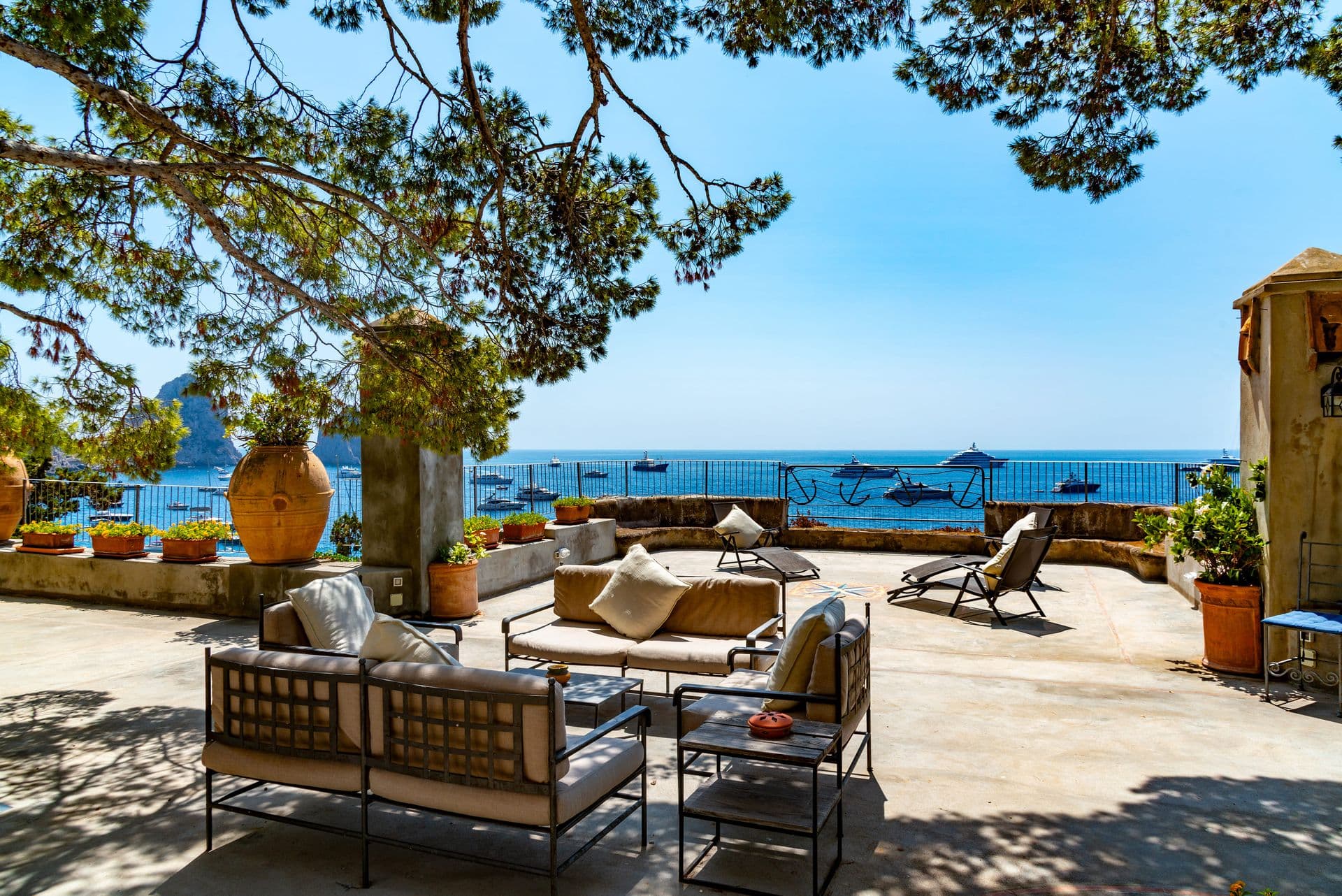 Terrace lounge with terracotta urns overlooking the bay at Faraglioni Frills, Capri