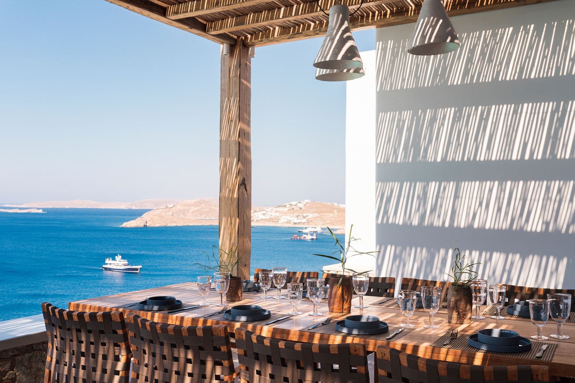 Outdoor dining terrace at Goddess of the Clouds overlooking the coastal town.
