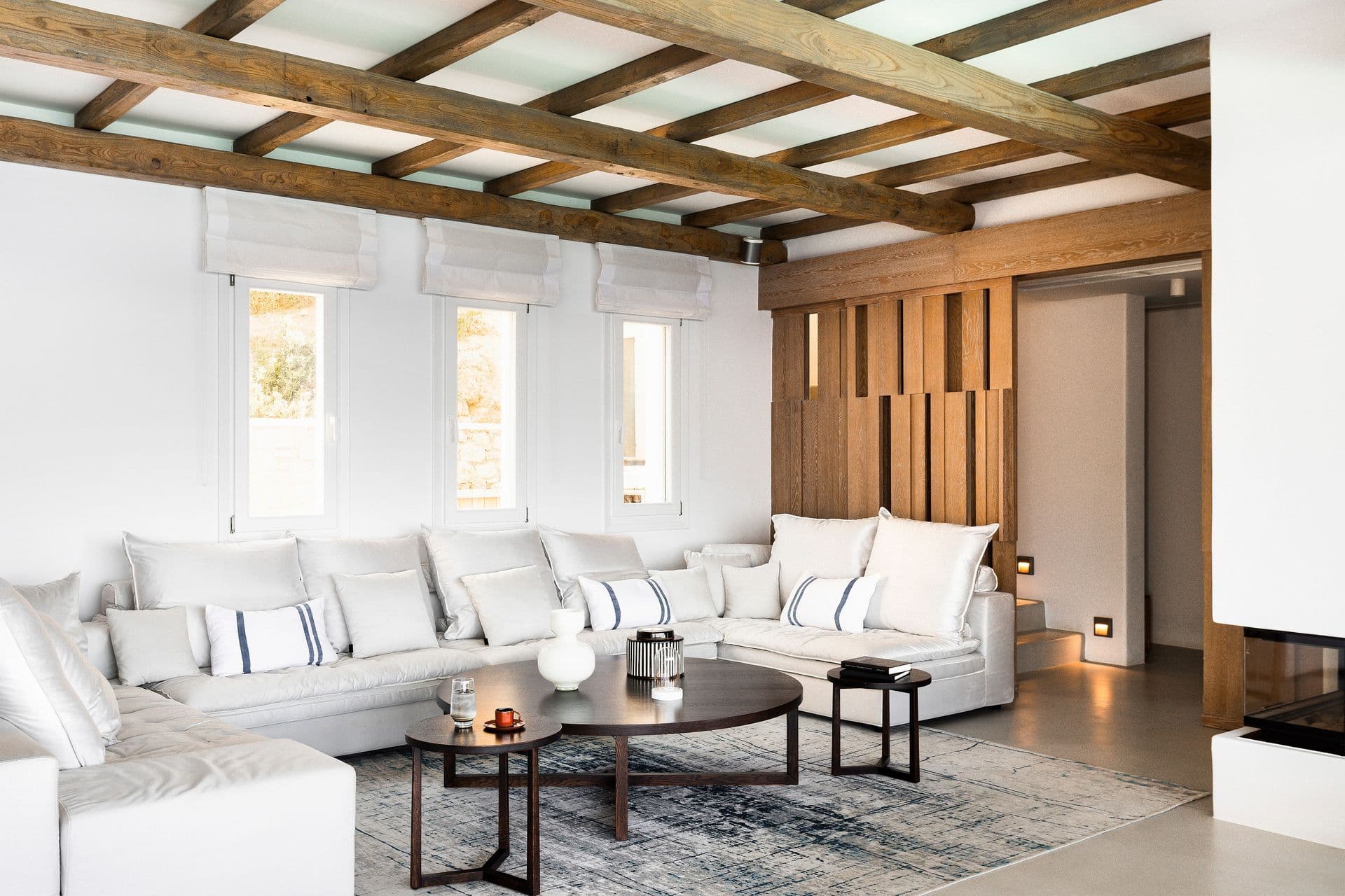 Living room at Goddess of the Clouds with white sofas and a wood beamed ceiling.
