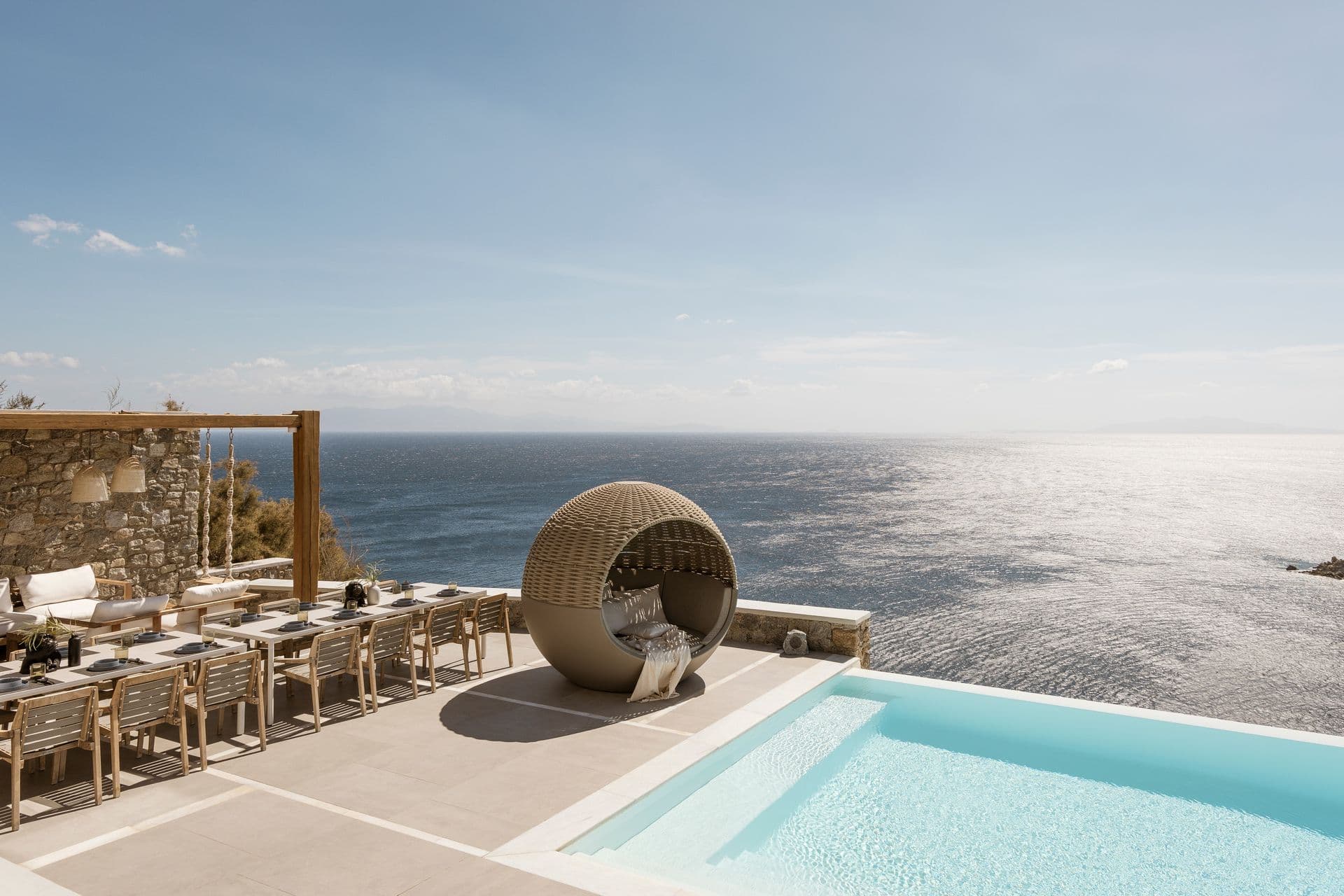 Pergola terrace at Goddess of the Clouds with a woven egg chair and open sea views.
