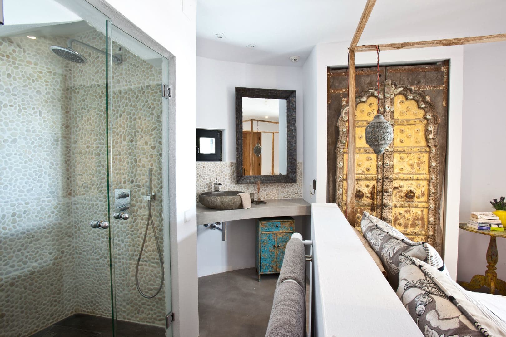 Bathroom with a mosaic walk-in shower and a carved Indian door at Cicadas Sway, Ibiza