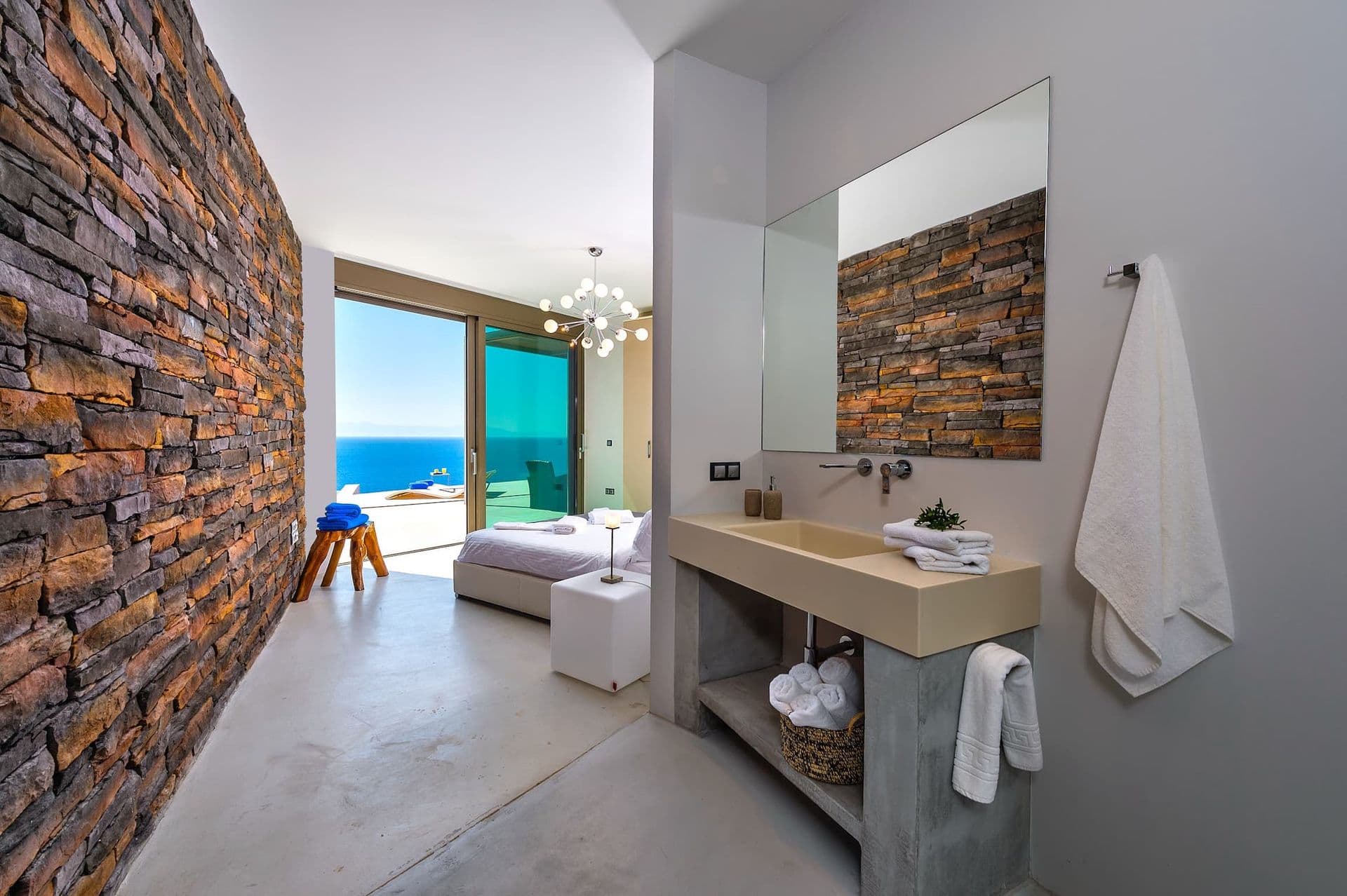 En-suite bathroom corridor with a sea view beyond the vanity.