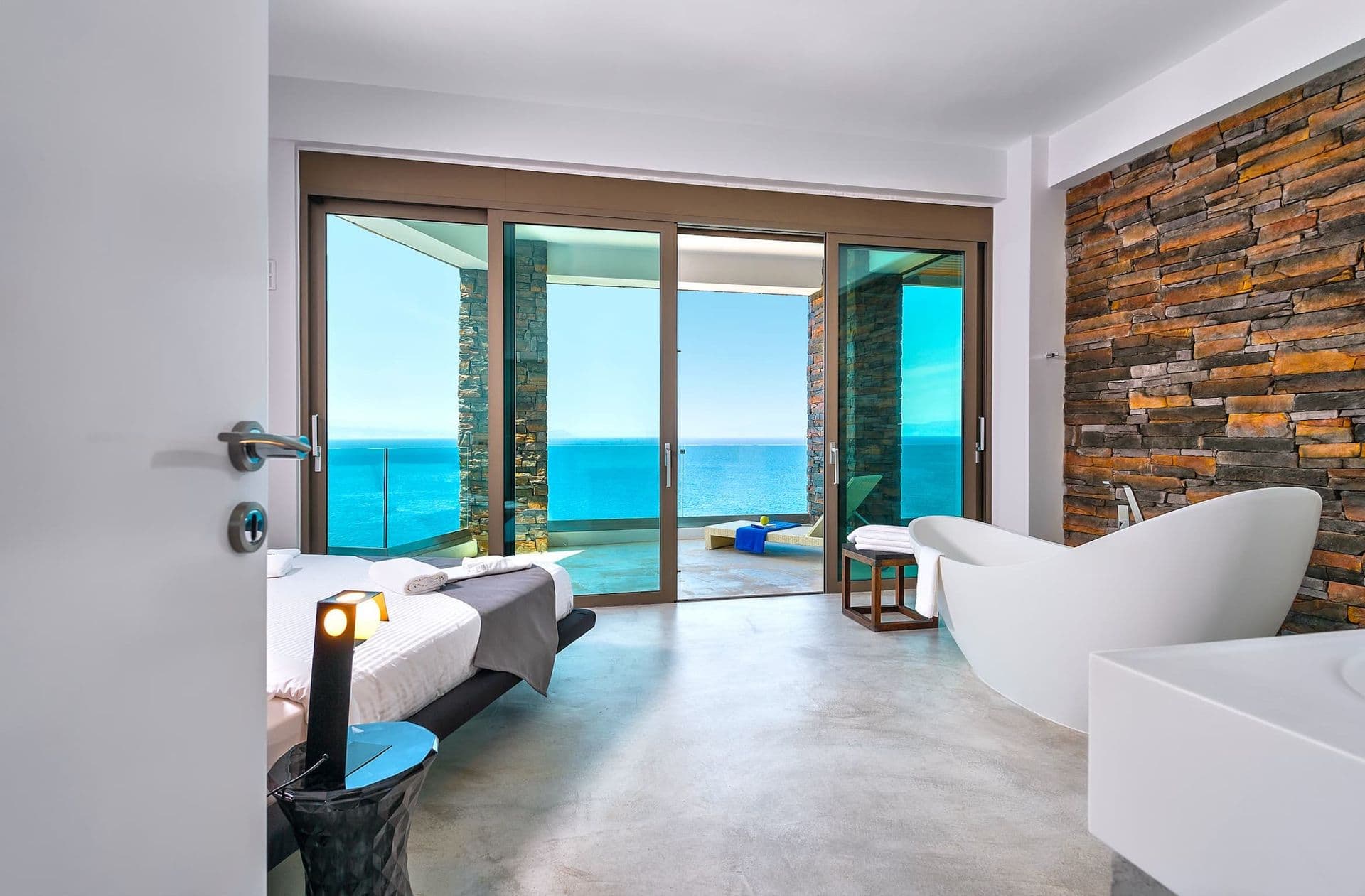 Bedroom with a private seating nook and direct sea view.