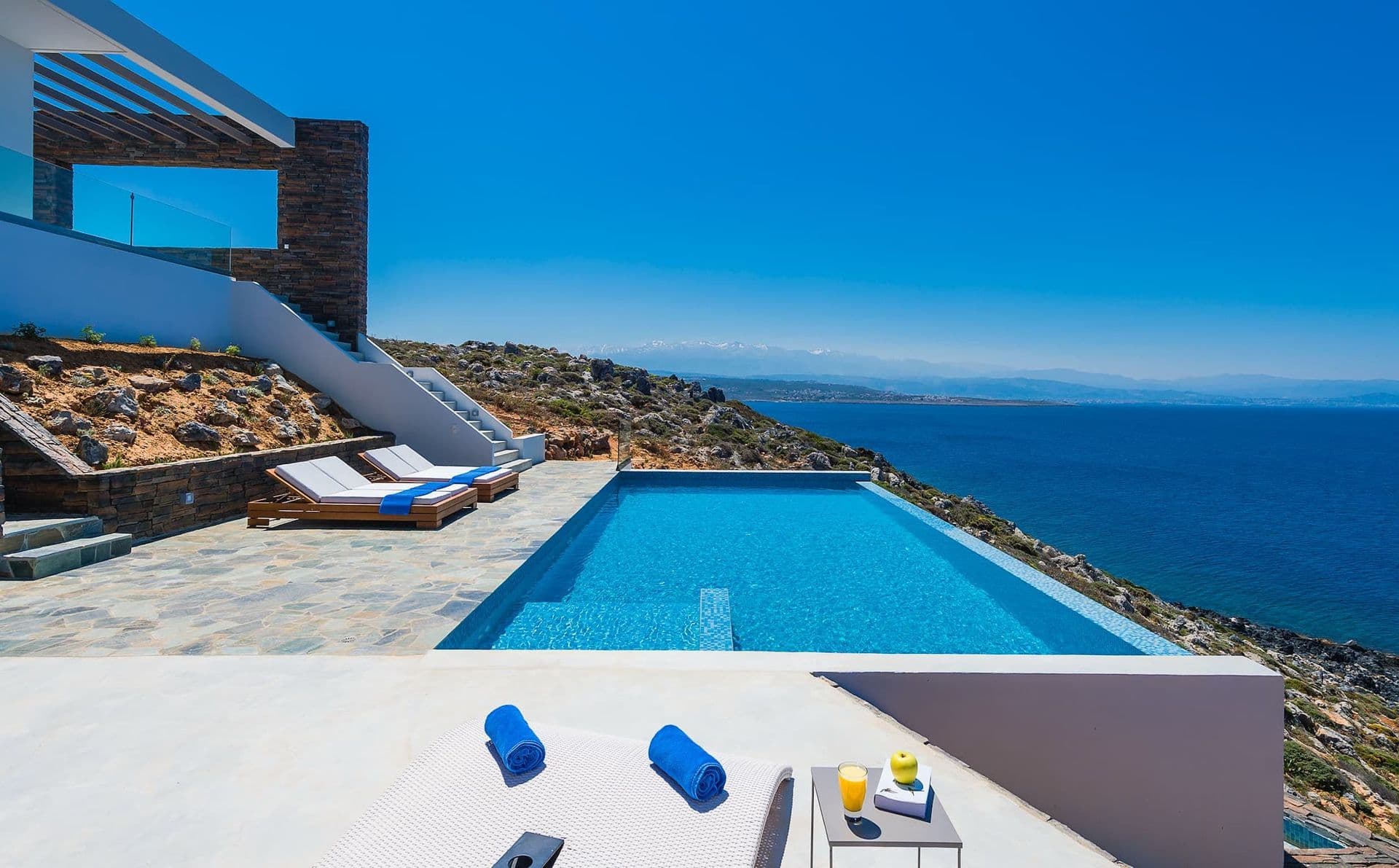 Infinity pool perched on the clifftop with uninterrupted Aegean Sea views at On The Water's Edge, Crete.