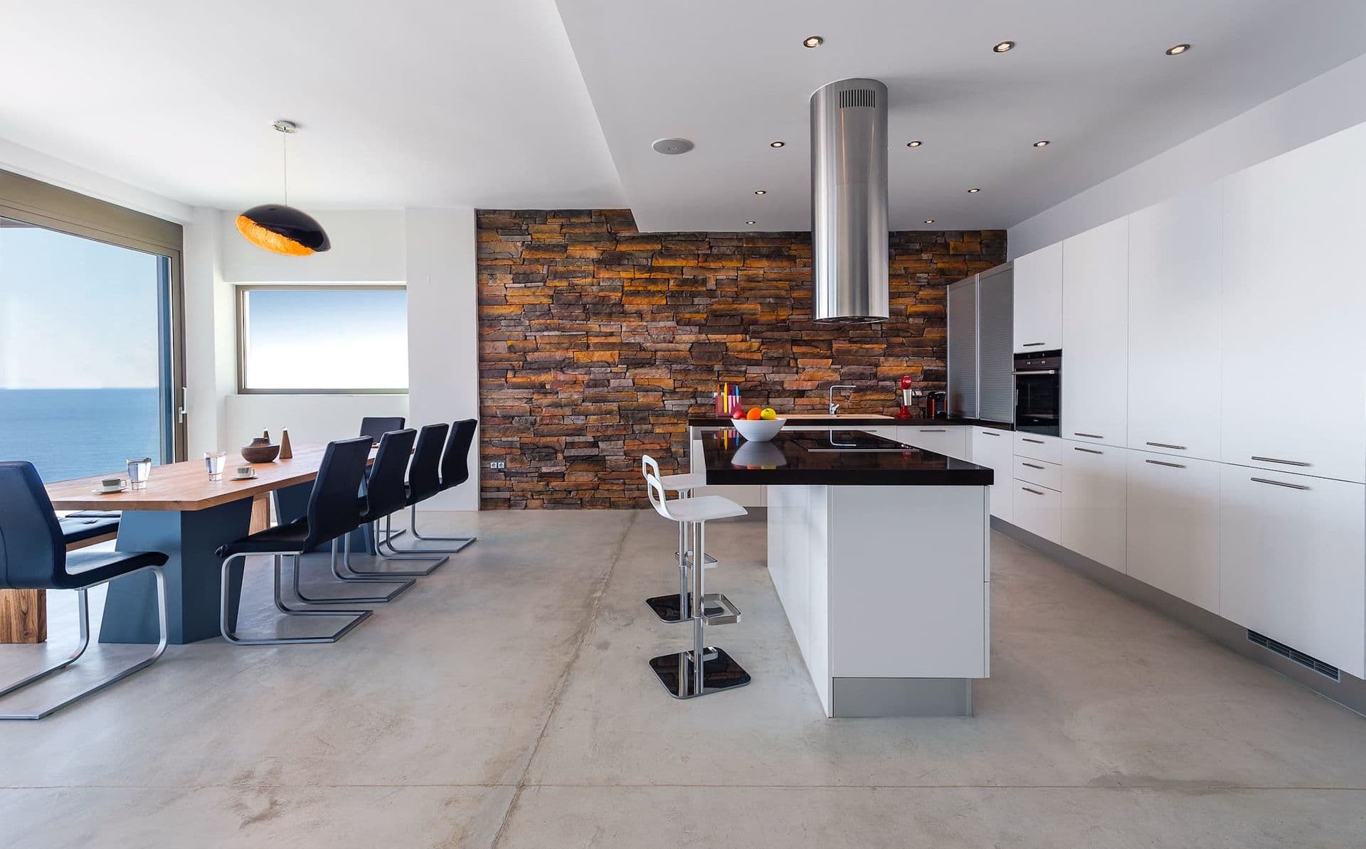 Kitchen island with bar seating opening onto the dining area.