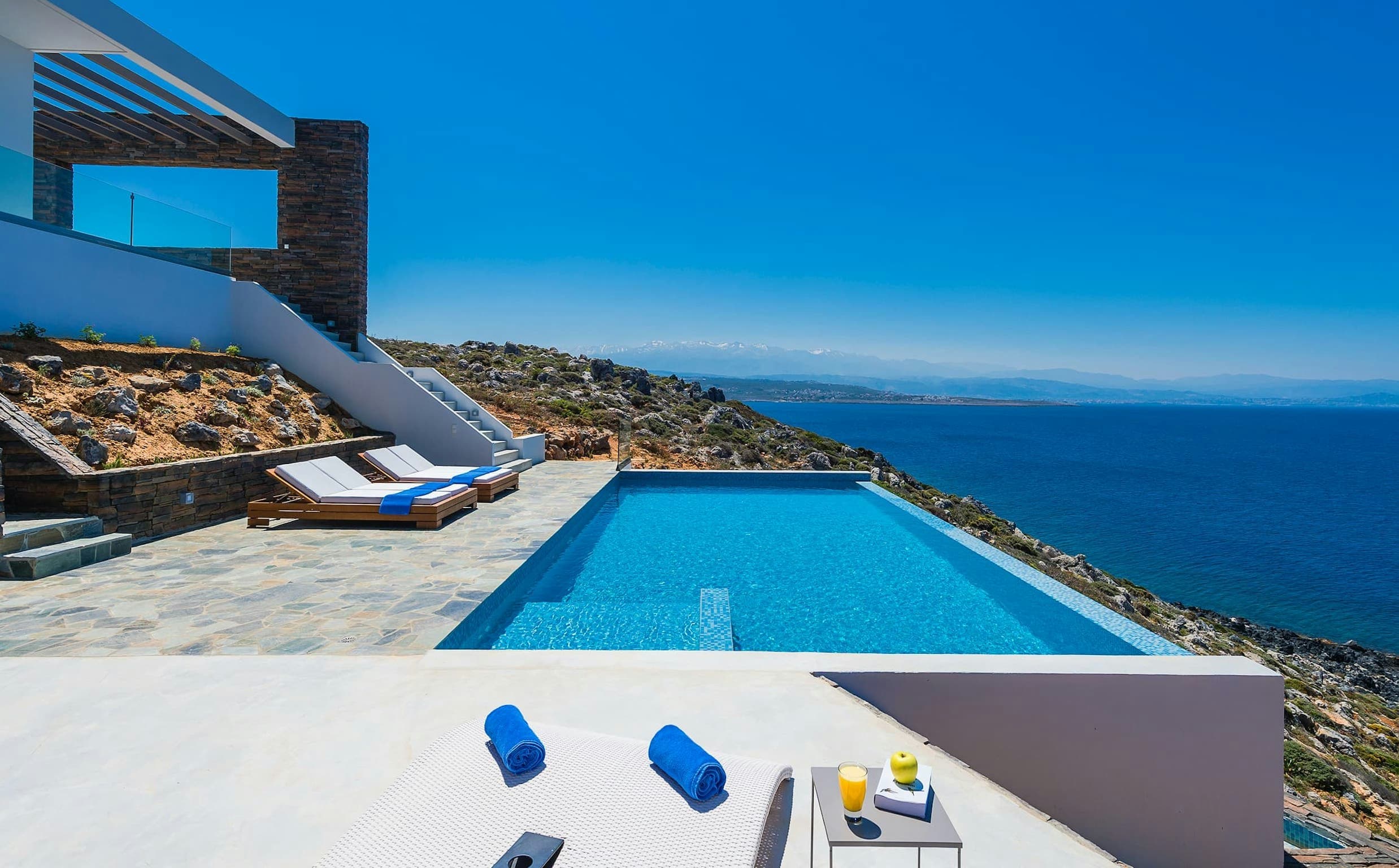 On The Water's Edge infinity pool and stone terrace overlooking the Aegean Sea, Santorini, Greece