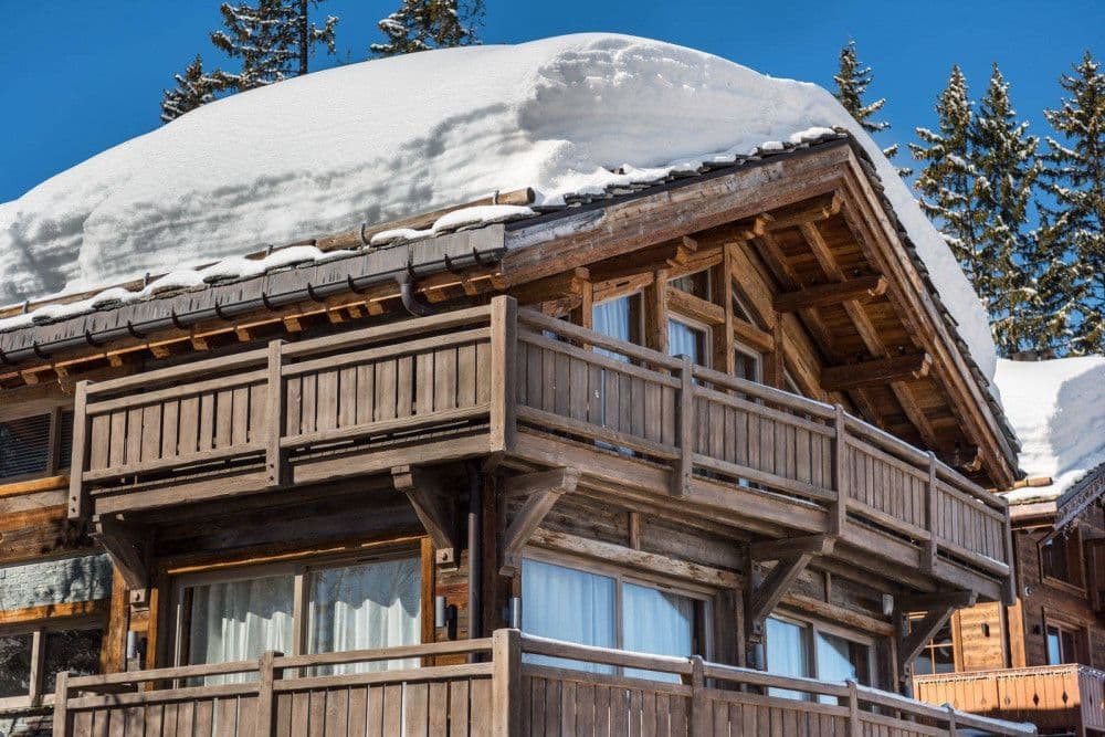 Snow-laden timber balcony and roof at Courchevel 26