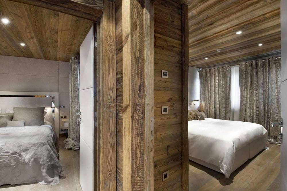 Guest bedroom panelled in old timber at Courchevel 26