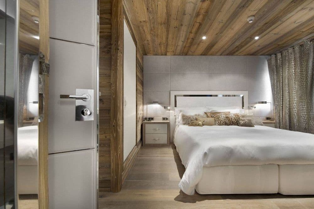 Master bedroom panelled in warm timber at Courchevel 26