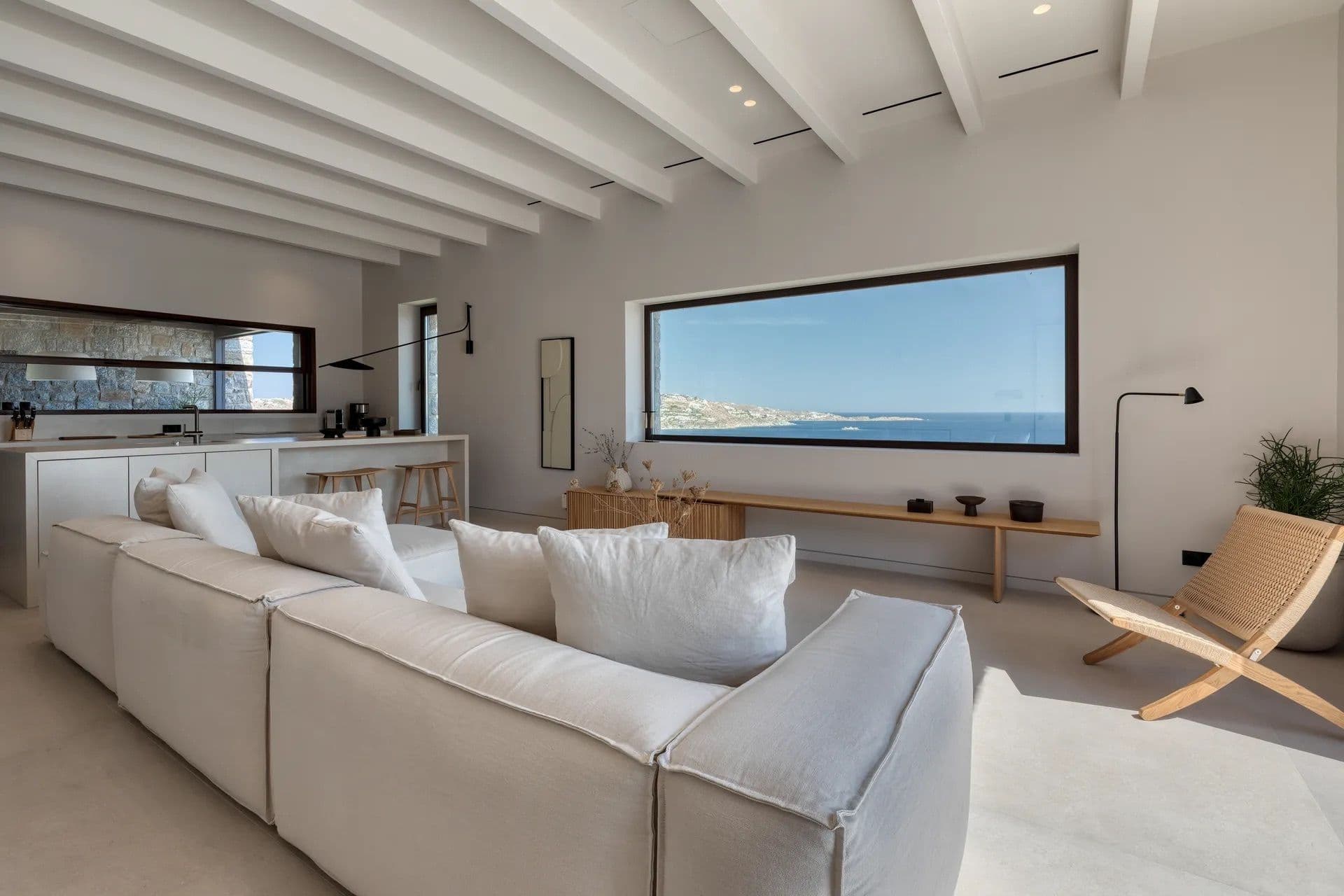 Living room with a built-in window bench framing a sea view
