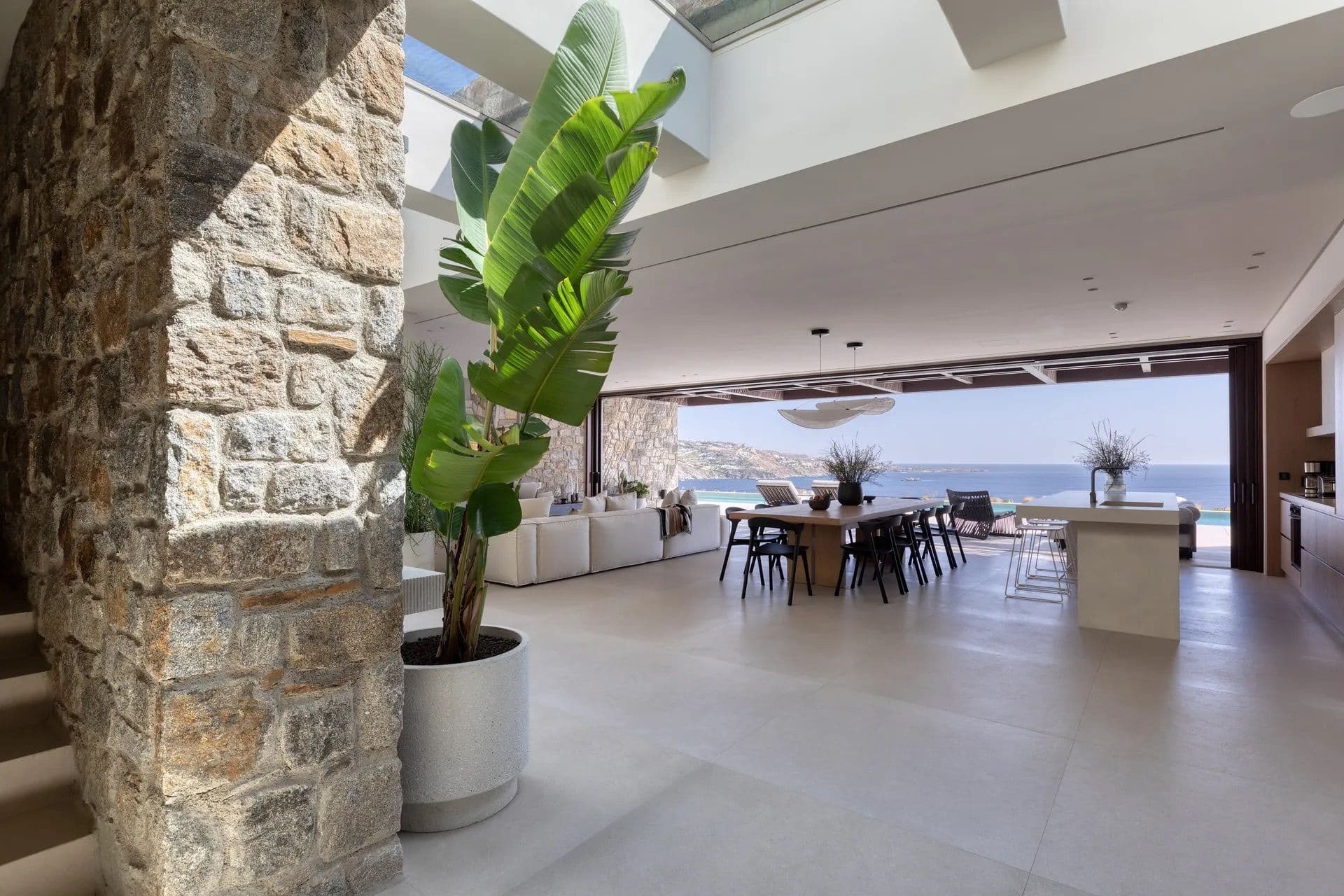 Stone archway entrance opening onto the villa's bright interior