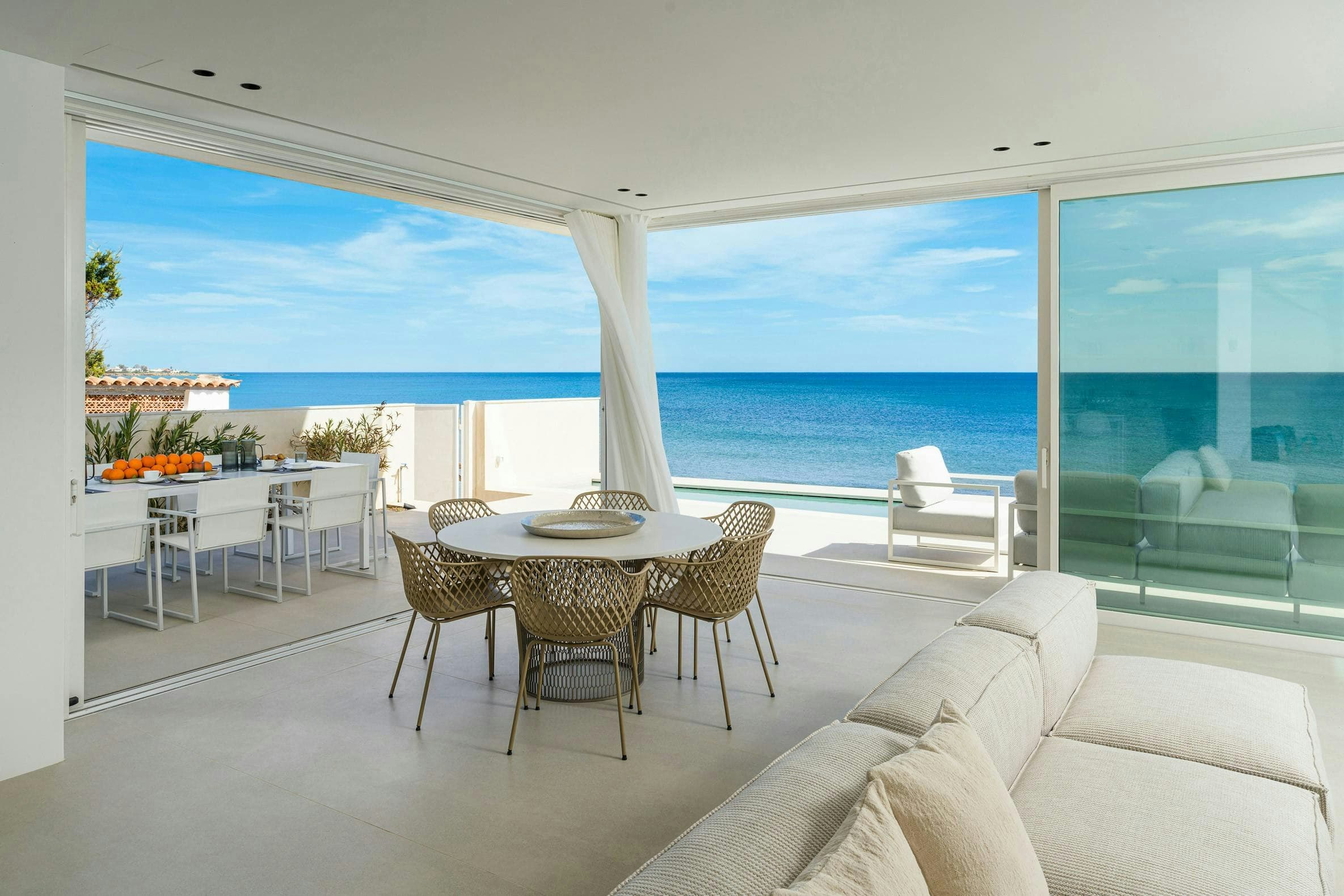 A Splash of Tangerine open-plan living room with ocean terrace, Marina di Noto, Sicily, Italy