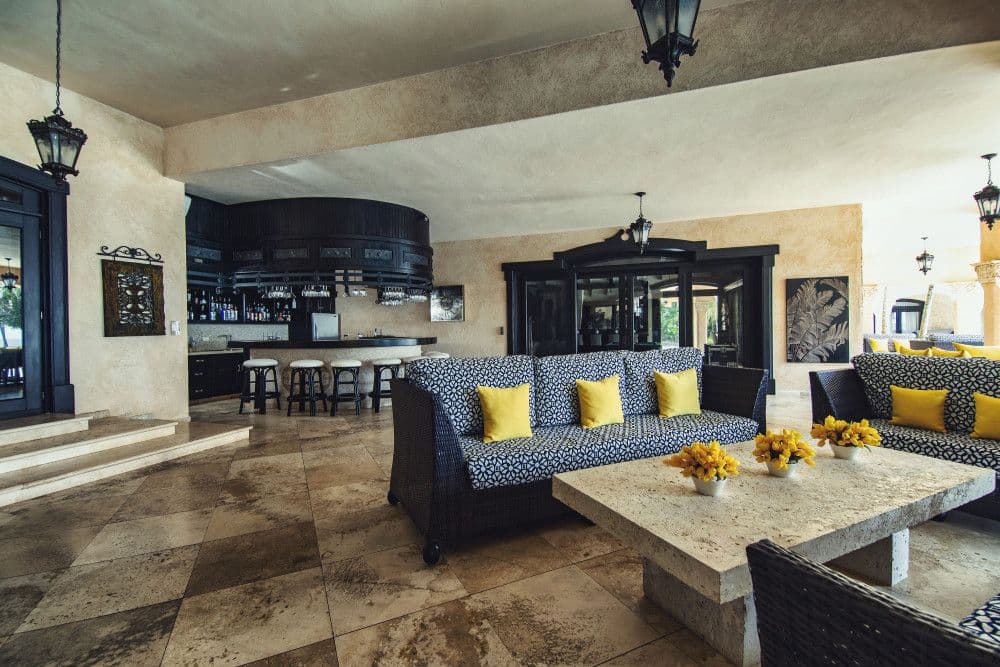 Covered lounge with a wet bar and seating at Villa Anacaona