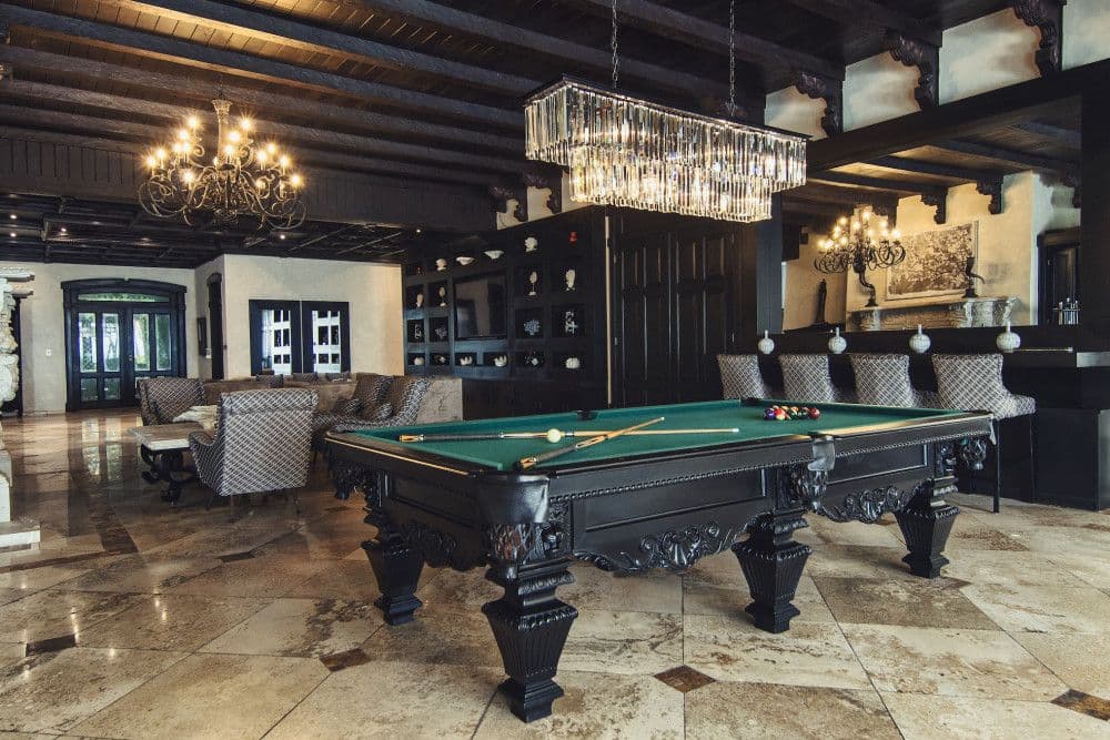 Games room with a billiards table and crystal chandelier