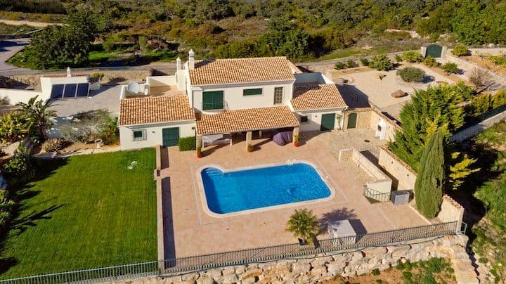 Aerial view of the villa, garden and pool set into the Algarve hills at Citrus, Peppers & Palms, Portugal