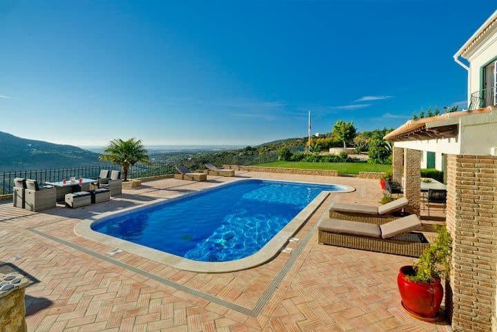 Poolside terrace with lounge seating overlooking the hills at Citrus, Peppers & Palms, Algarve