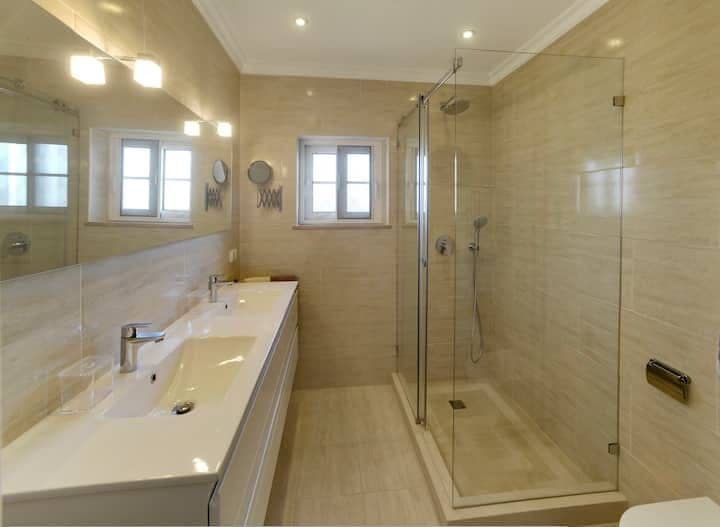 Bathroom with a double vanity and glazed walk-in shower at Citrus, Peppers & Palms, Algarve