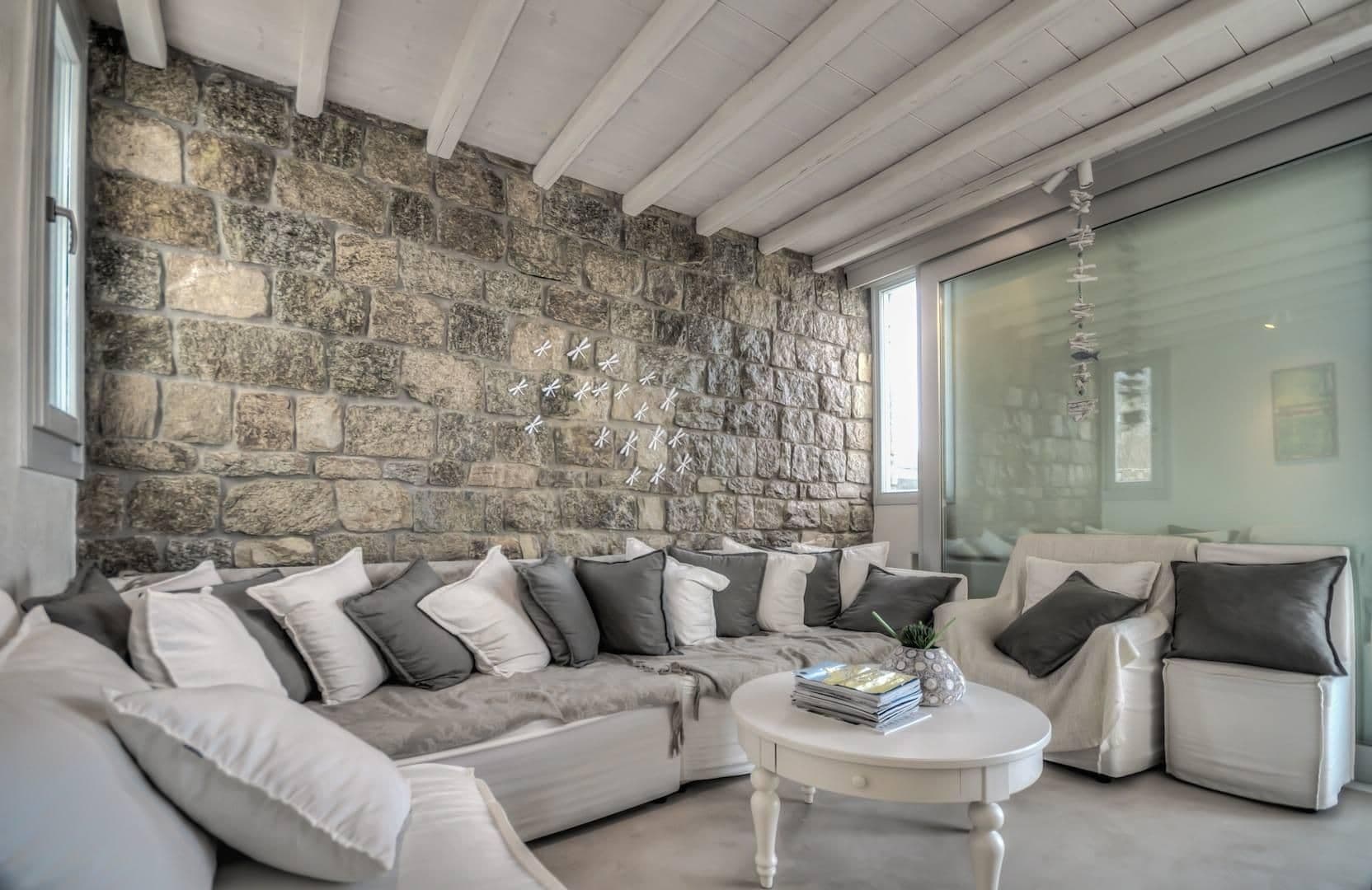 Living room with exposed stone wall and large corner sofa