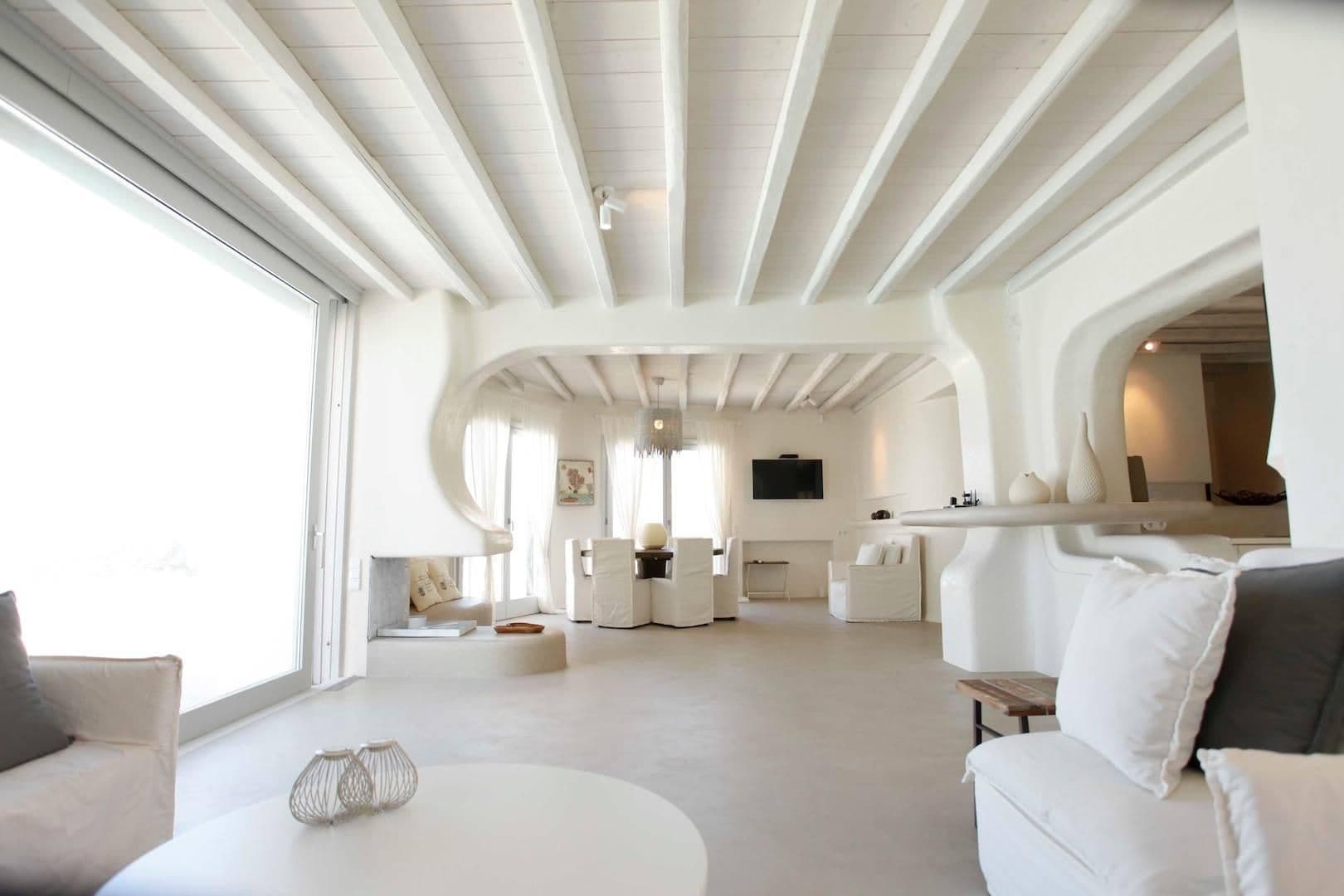 Open-plan living and dining area with curved white architectural details
