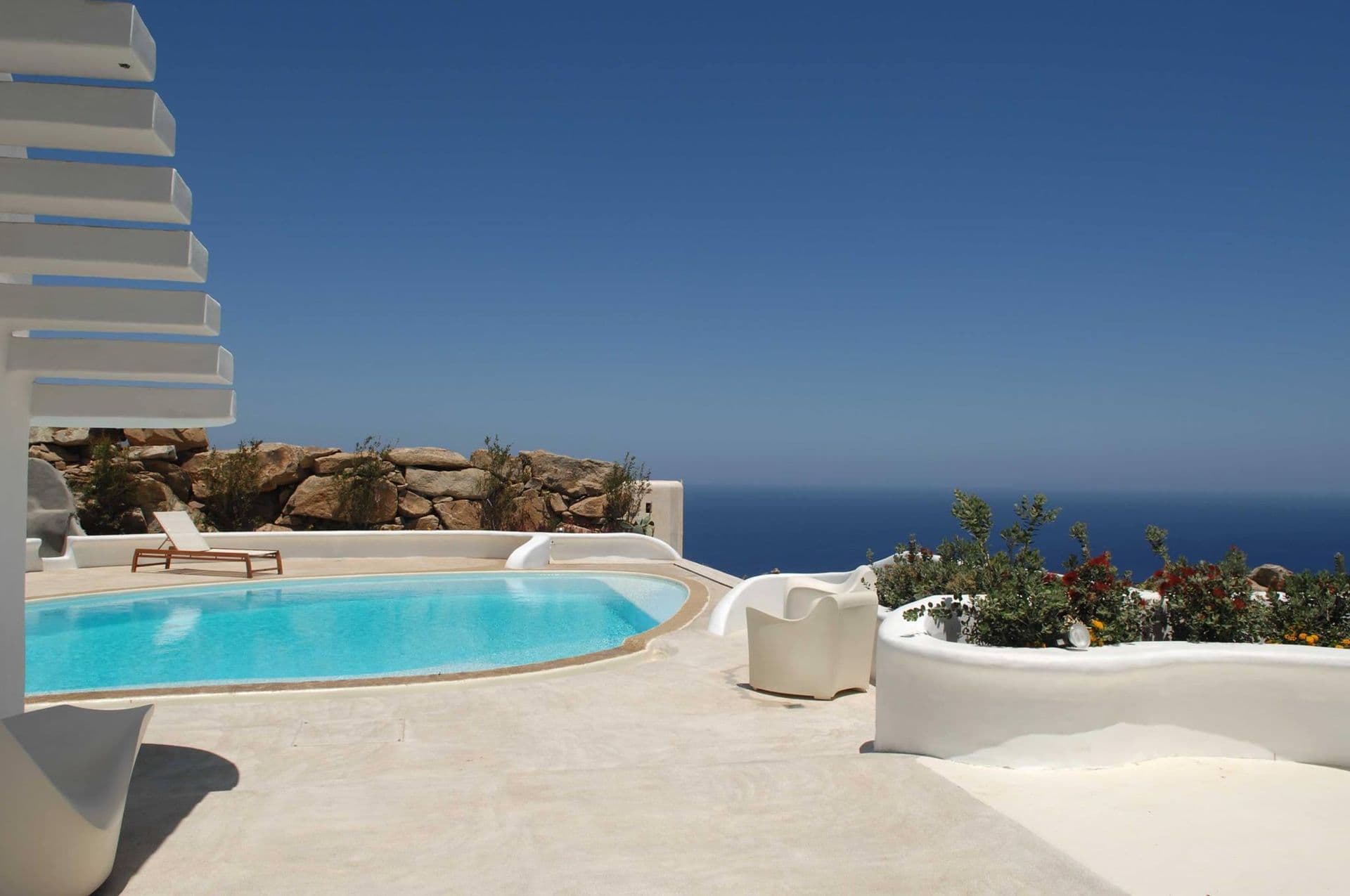 Organically shaped pool set against the rocky Mykonos hillside