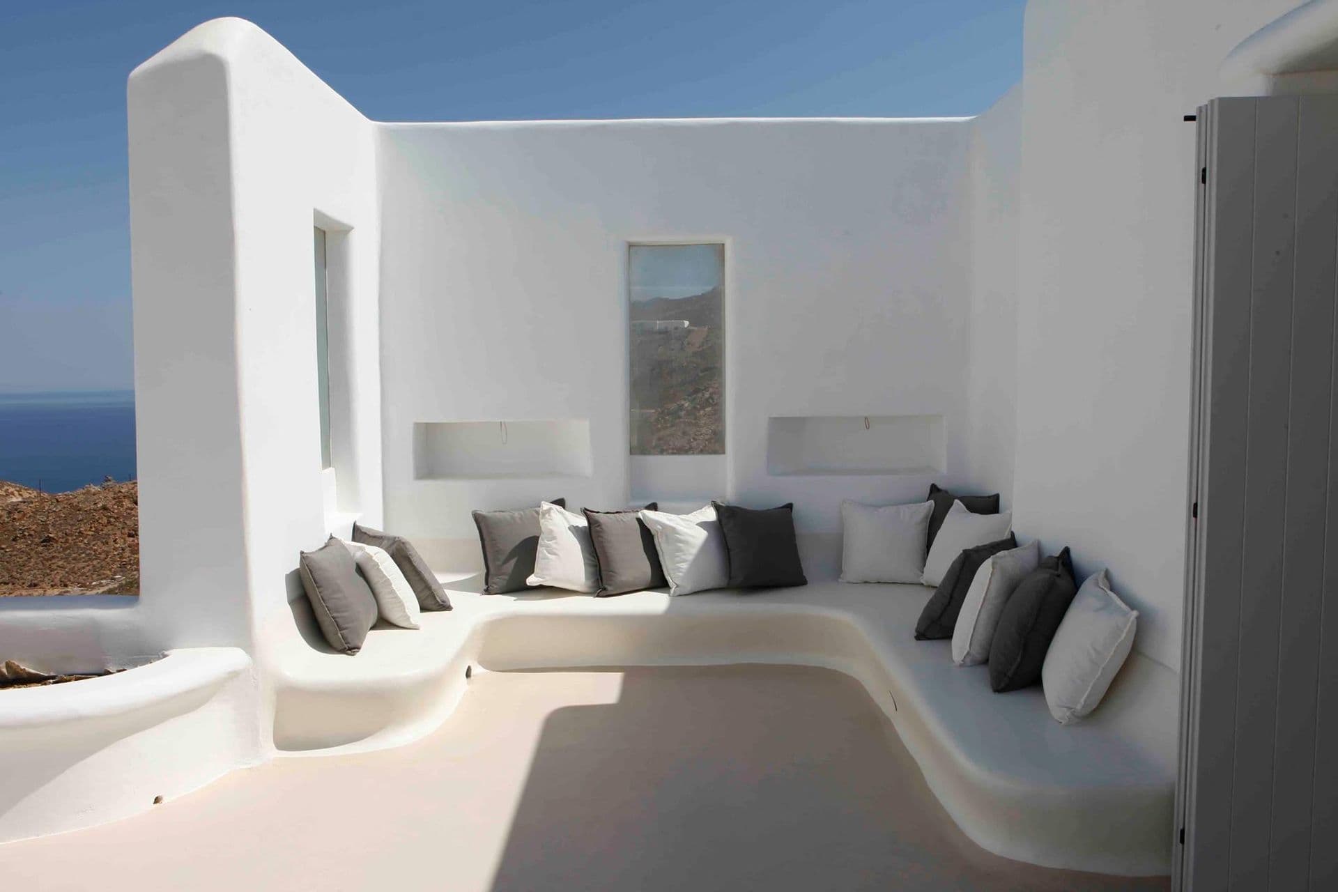 Sculptural curved white lounge seating opening onto the terrace