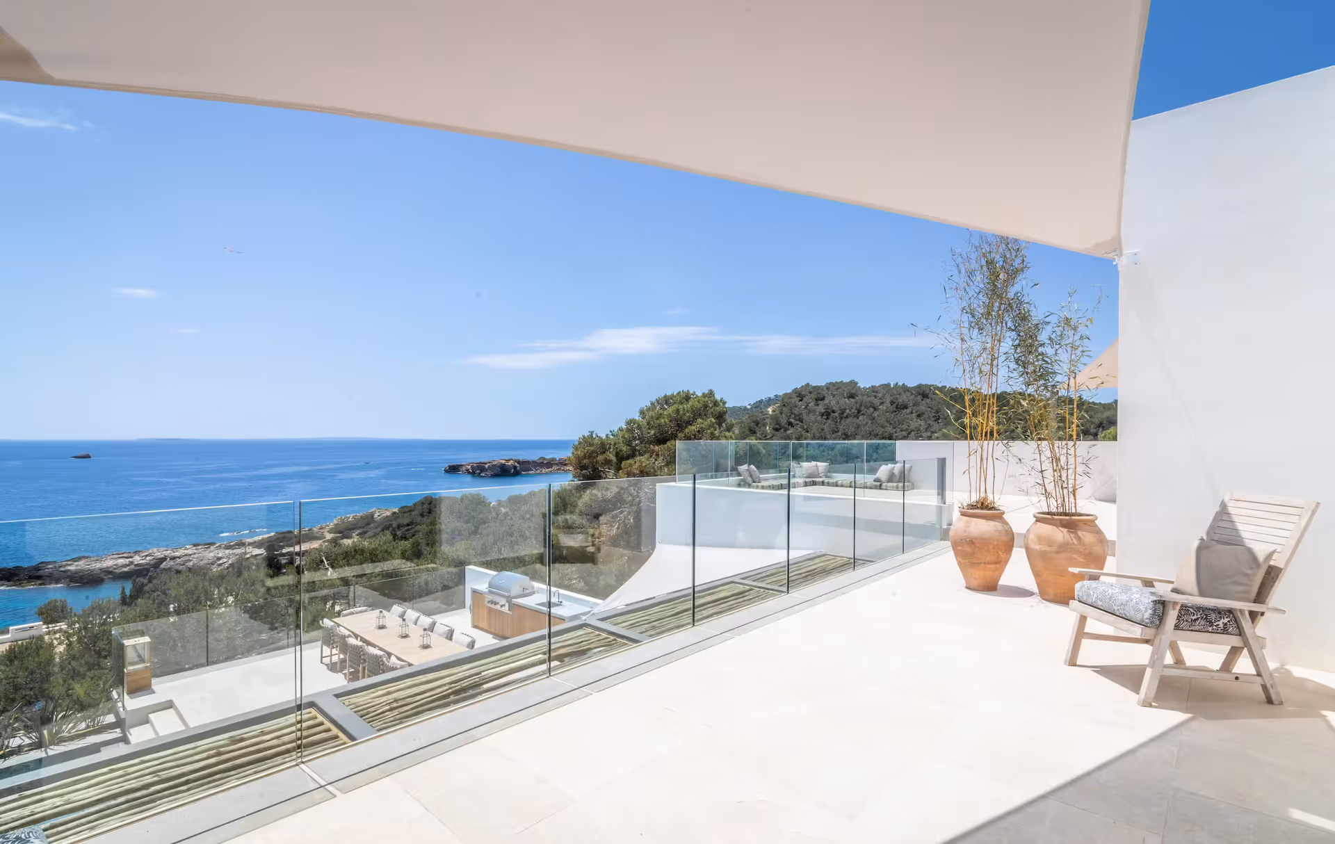 Open terrace with glass balustrade framing an uninterrupted sea view
