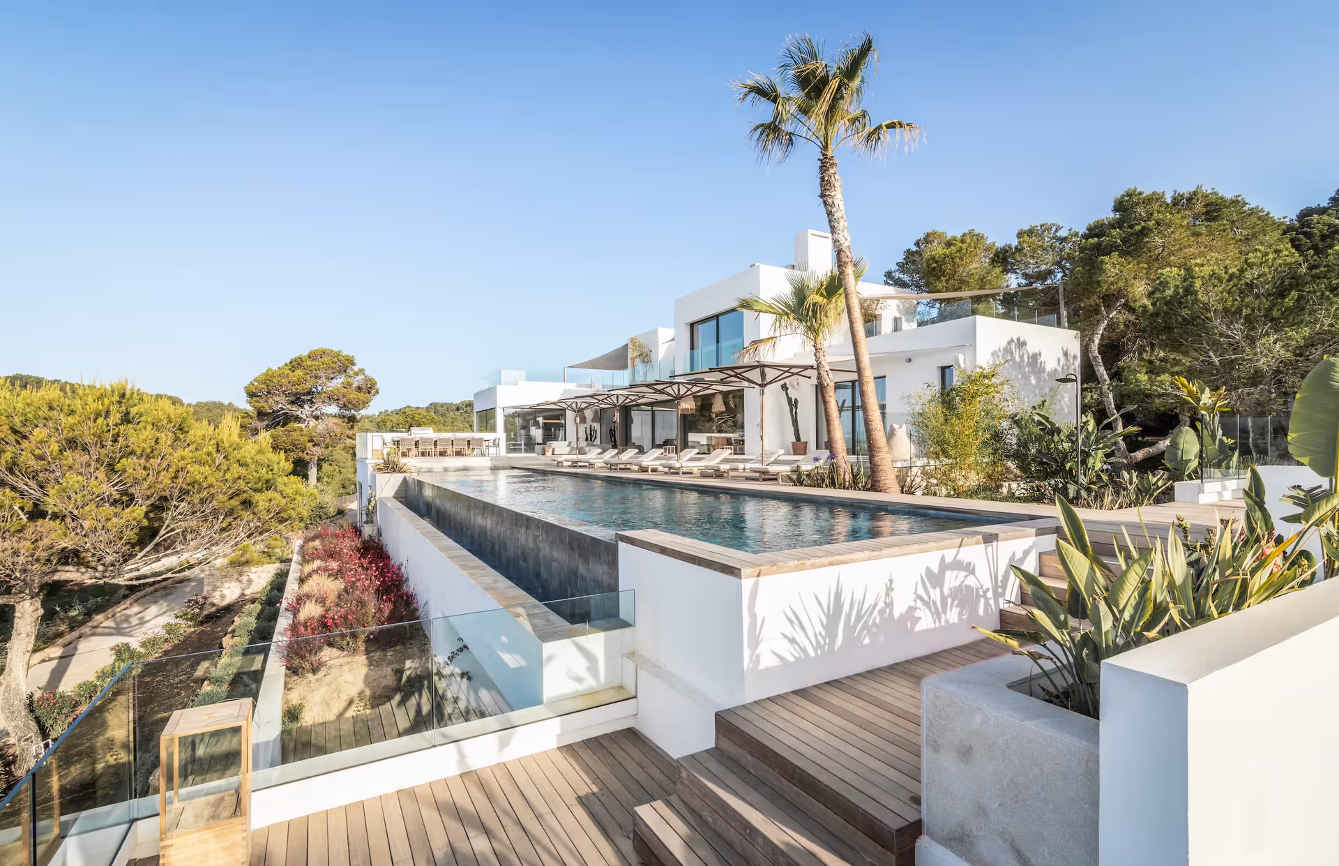 Tiered garden and pool terraces cascading down the clifftop plot