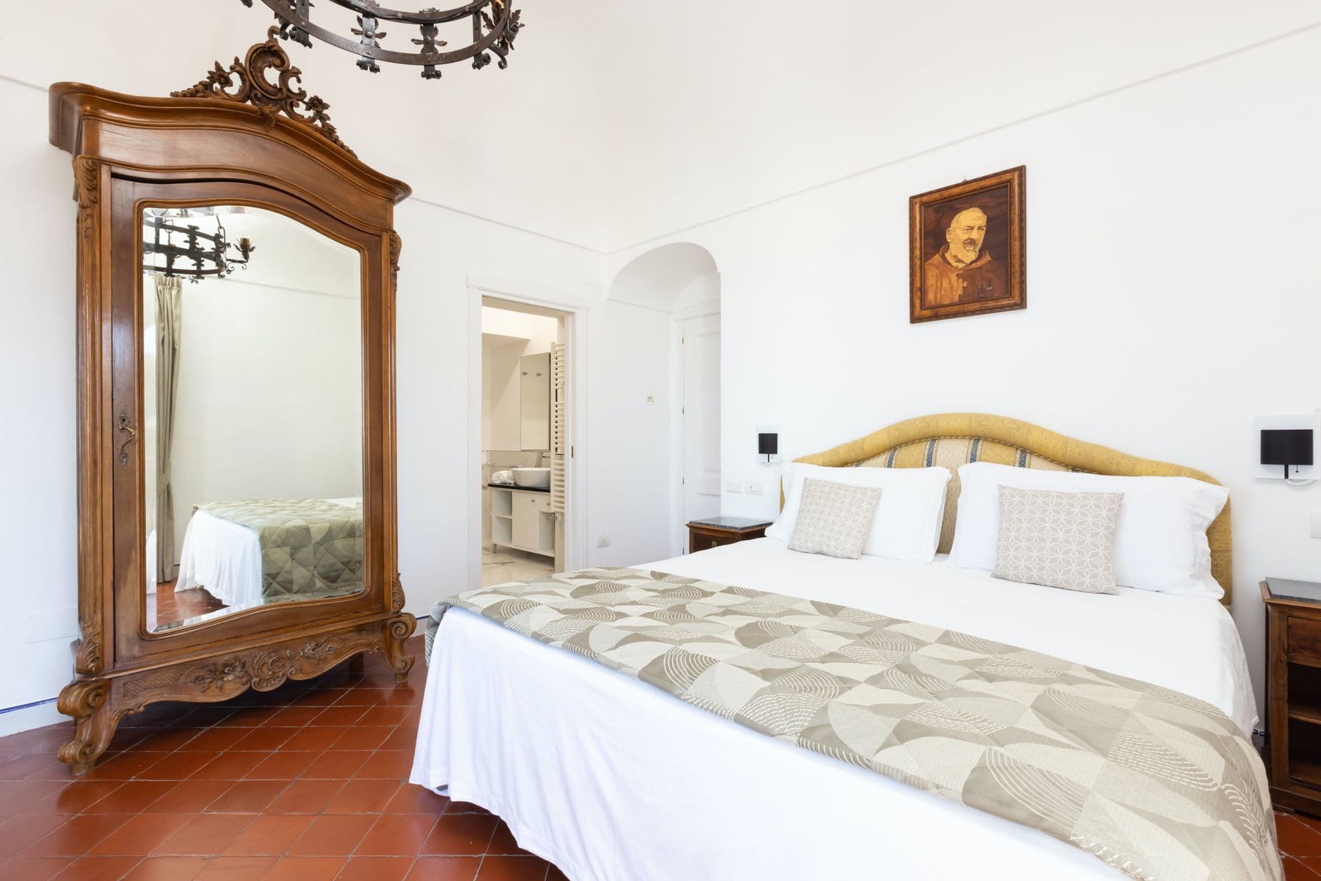 Bedroom with ornate antique mirror and period furniture at Pavillion Paradiso