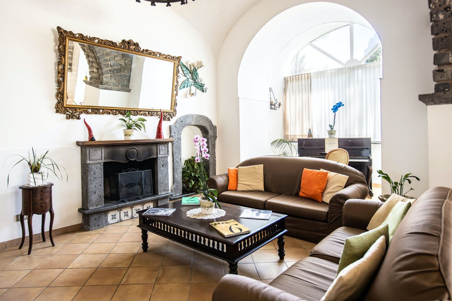 Living room with marble fireplace and antique furnishings at Pavillion Paradiso