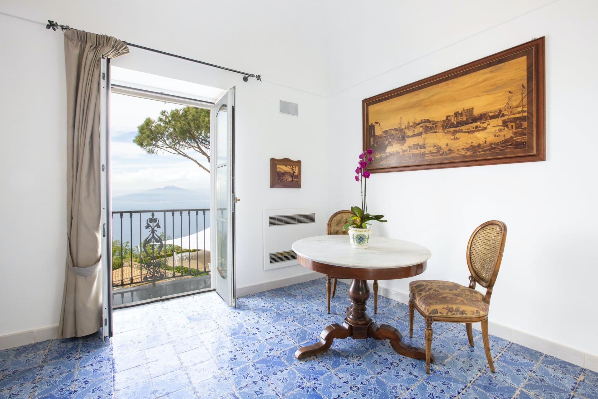 Sitting room opening onto a balcony with sea views at Pavillion Paradiso