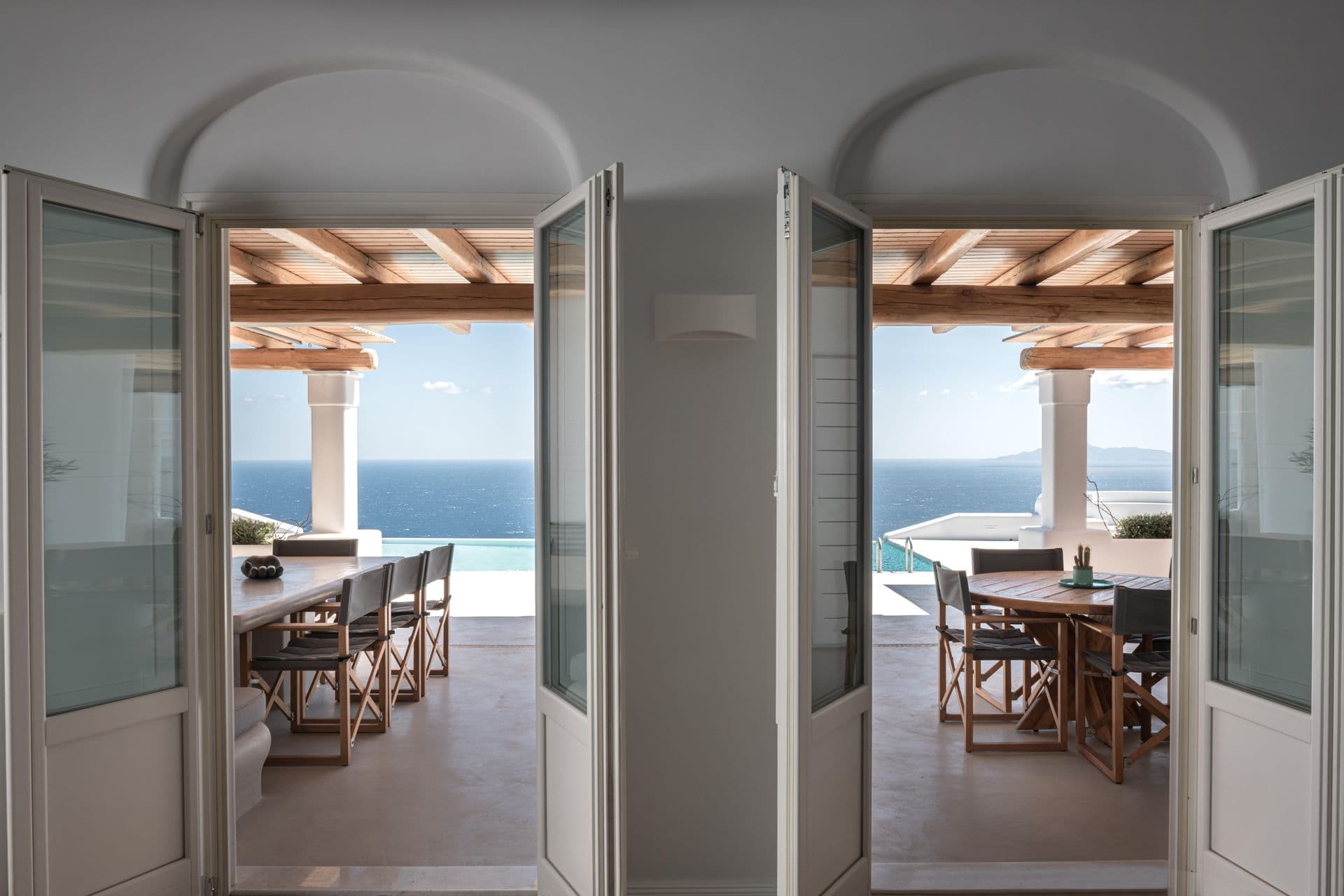 Dining room with French doors opening directly onto the sea-view terrace