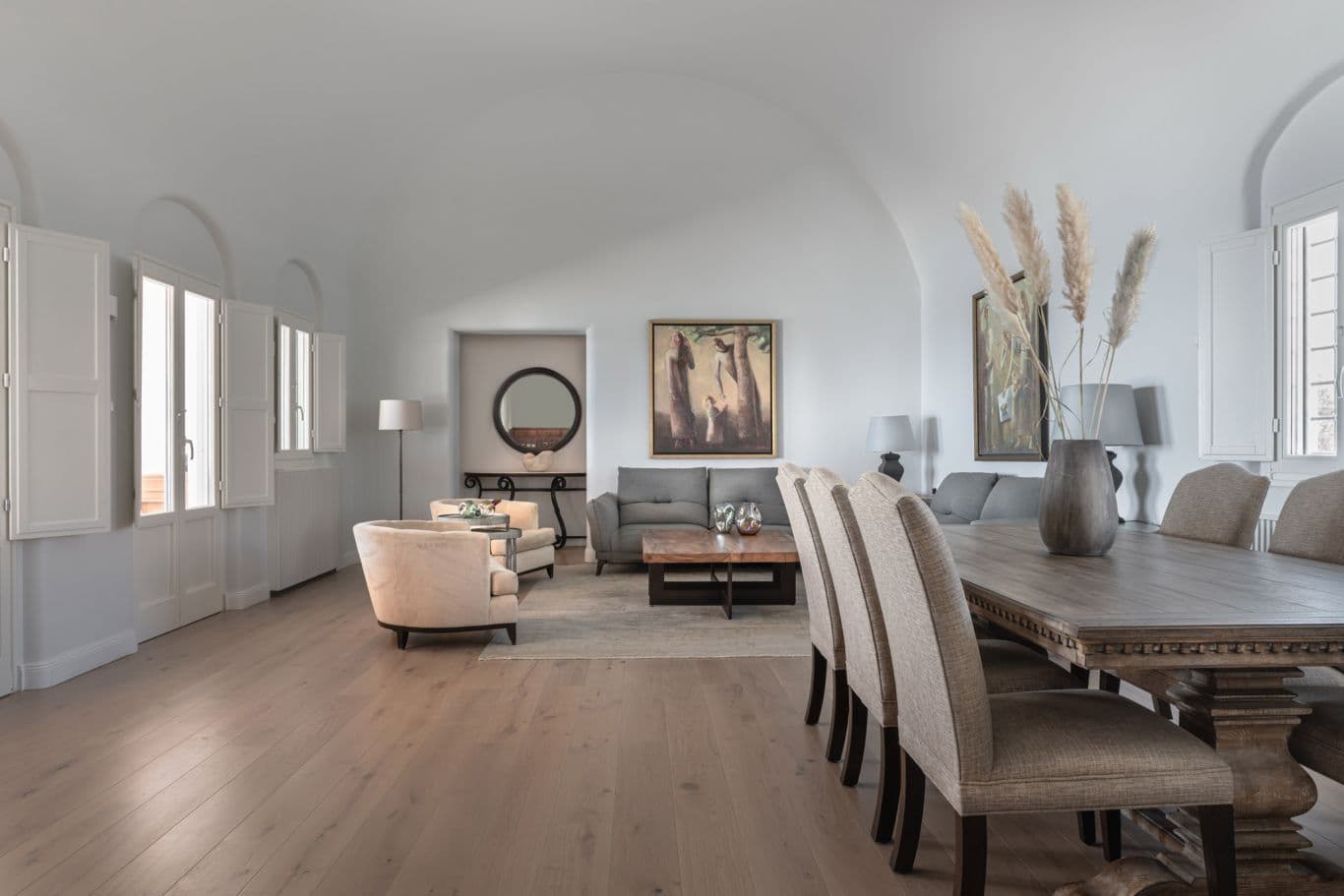 Open-plan living and dining room with vaulted ceilings and light oak flooring