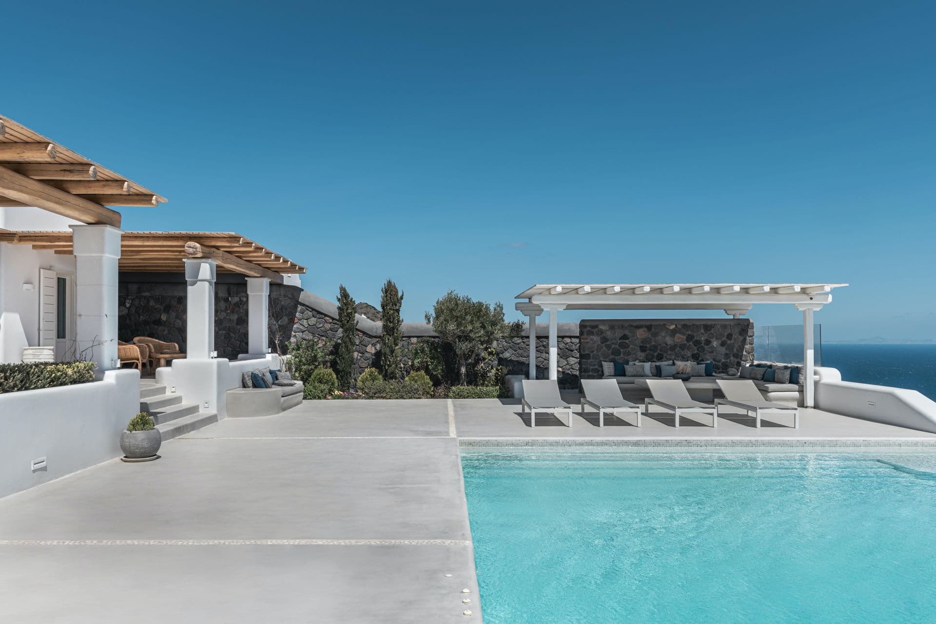 Whitewashed Santorini villa Whisper of the Sea in Imerovigli with a pergola-shaded pool terrace