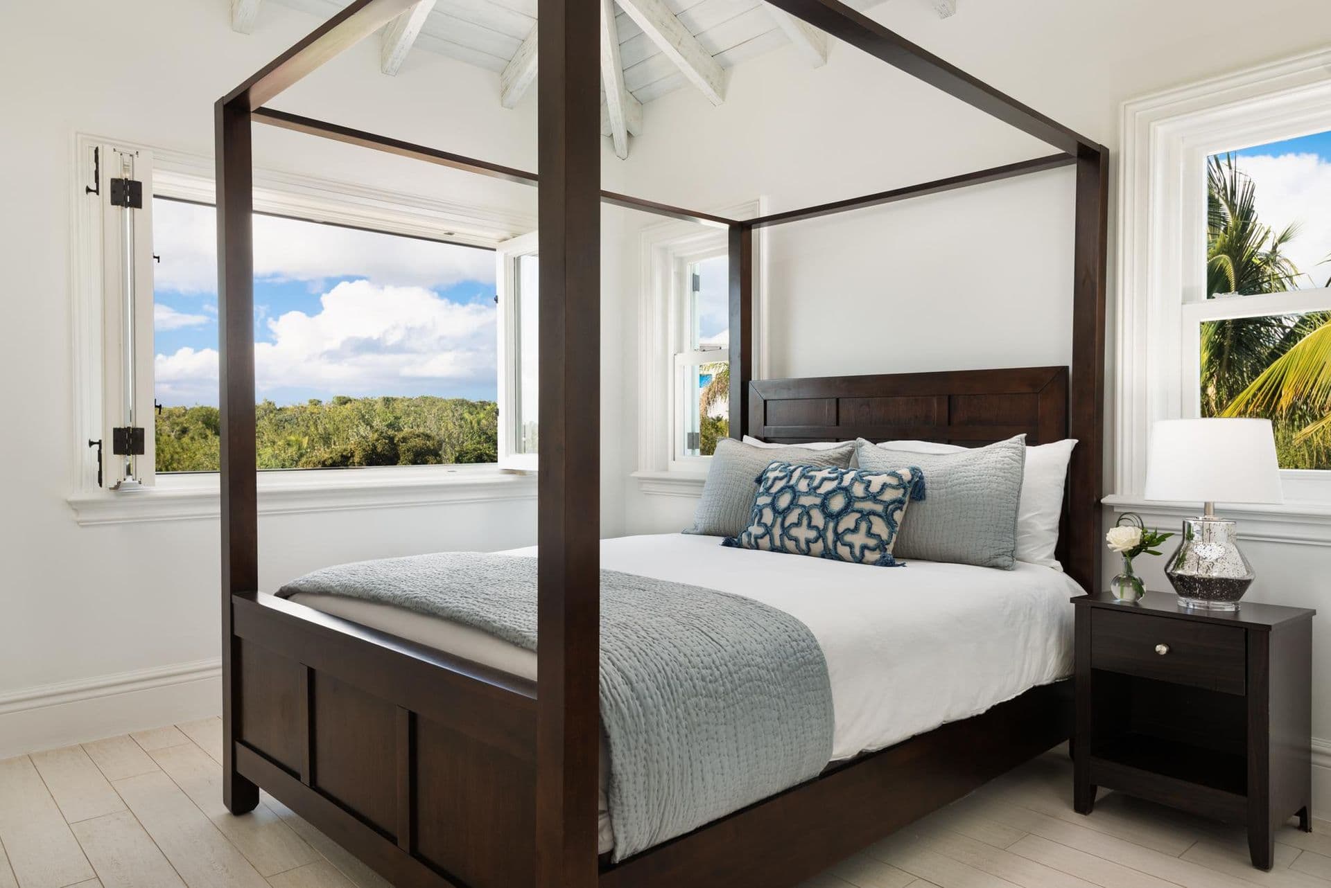 Guest bedroom with dark wood four-poster canopy bed