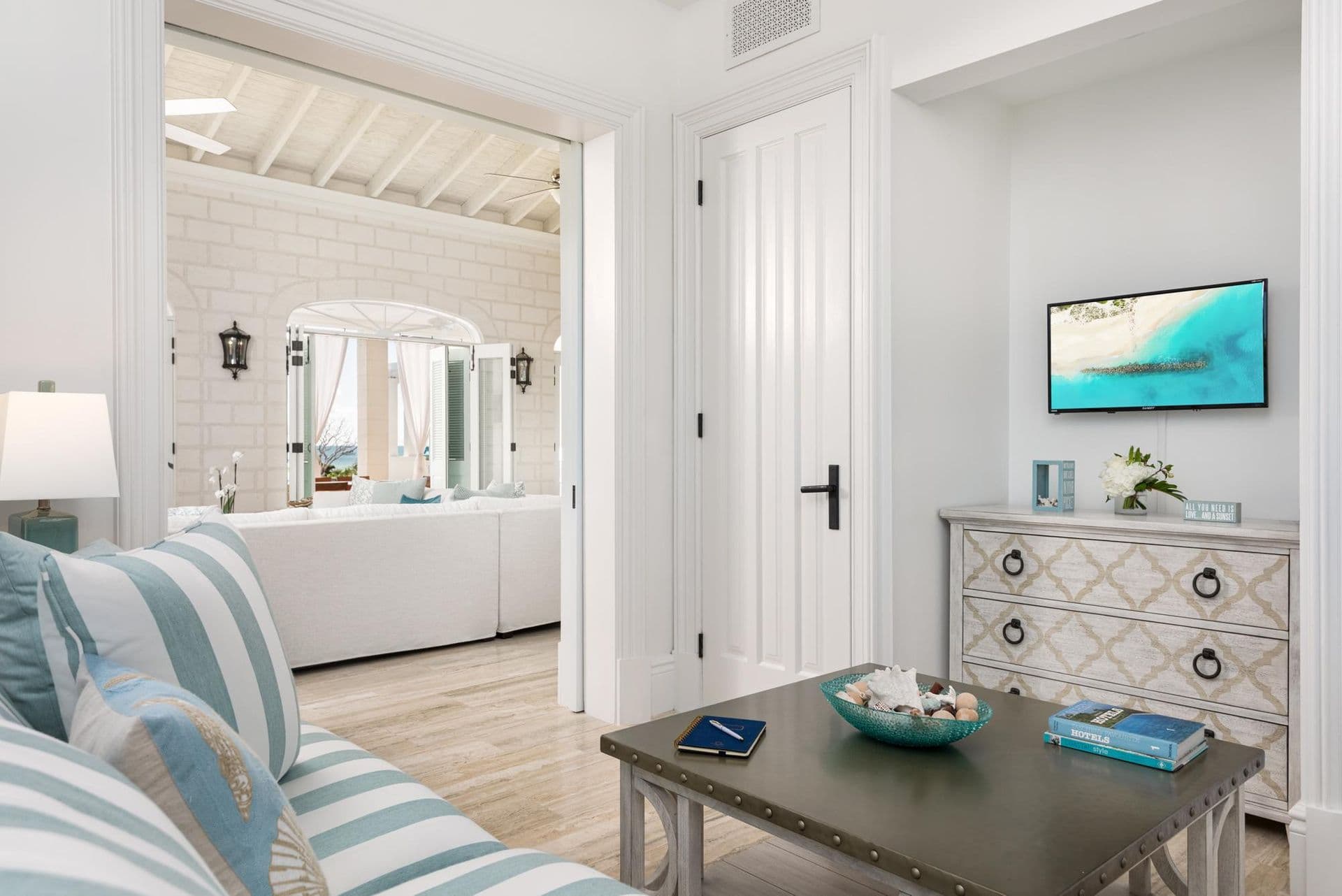 Coastal-styled lounge with striped sofa and television