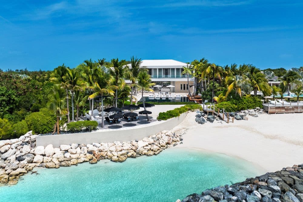 Villa Awa, a modern beachfront villa with a pool above a turquoise cove on Providenciales