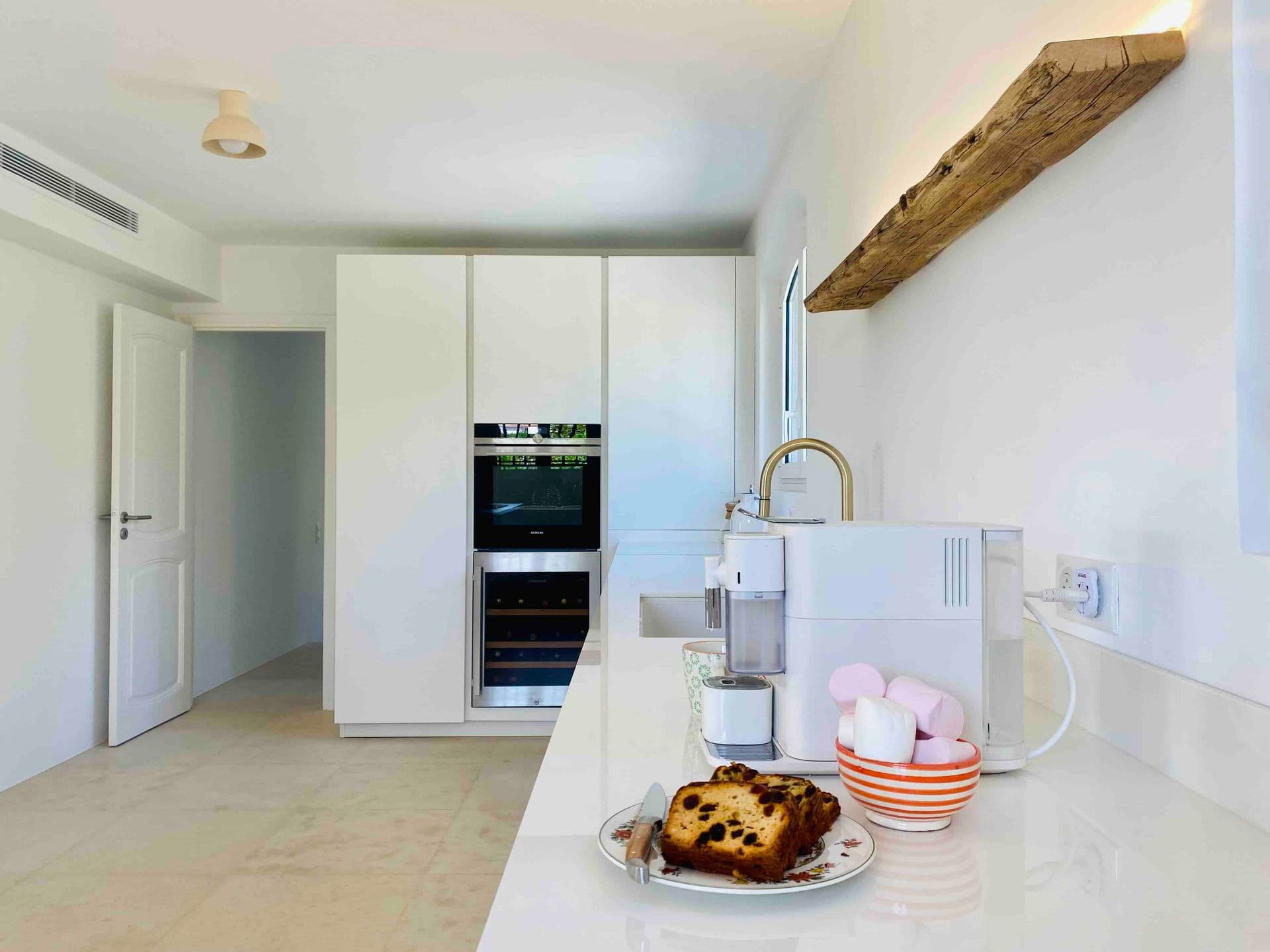 Kitchen counter with coffee machine and a freshly baked cake