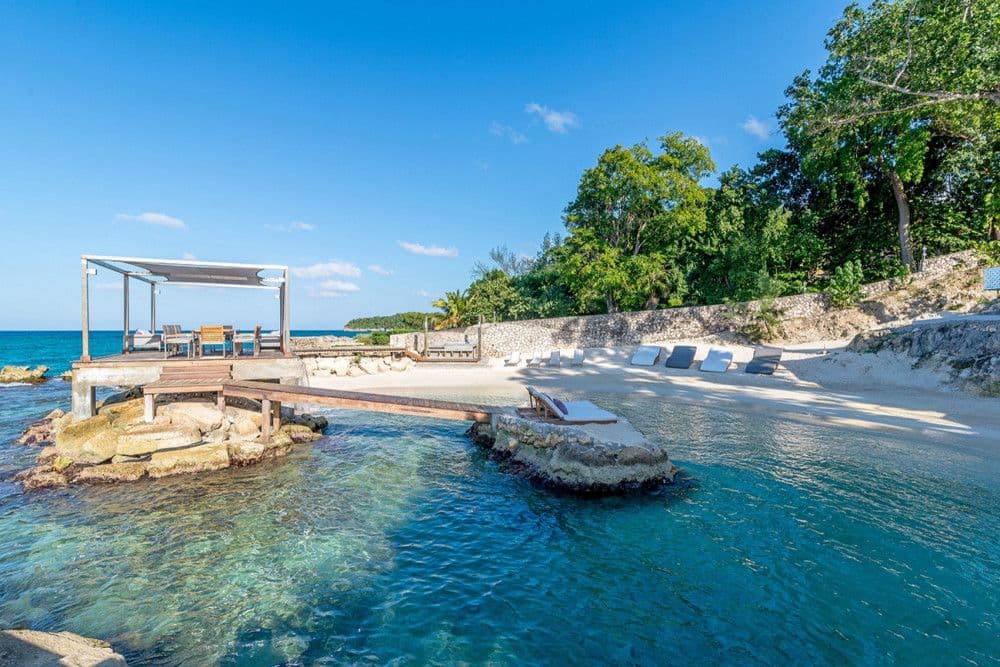 Beachfront gazebo on the rocks over a sheltered cove at Promiseas